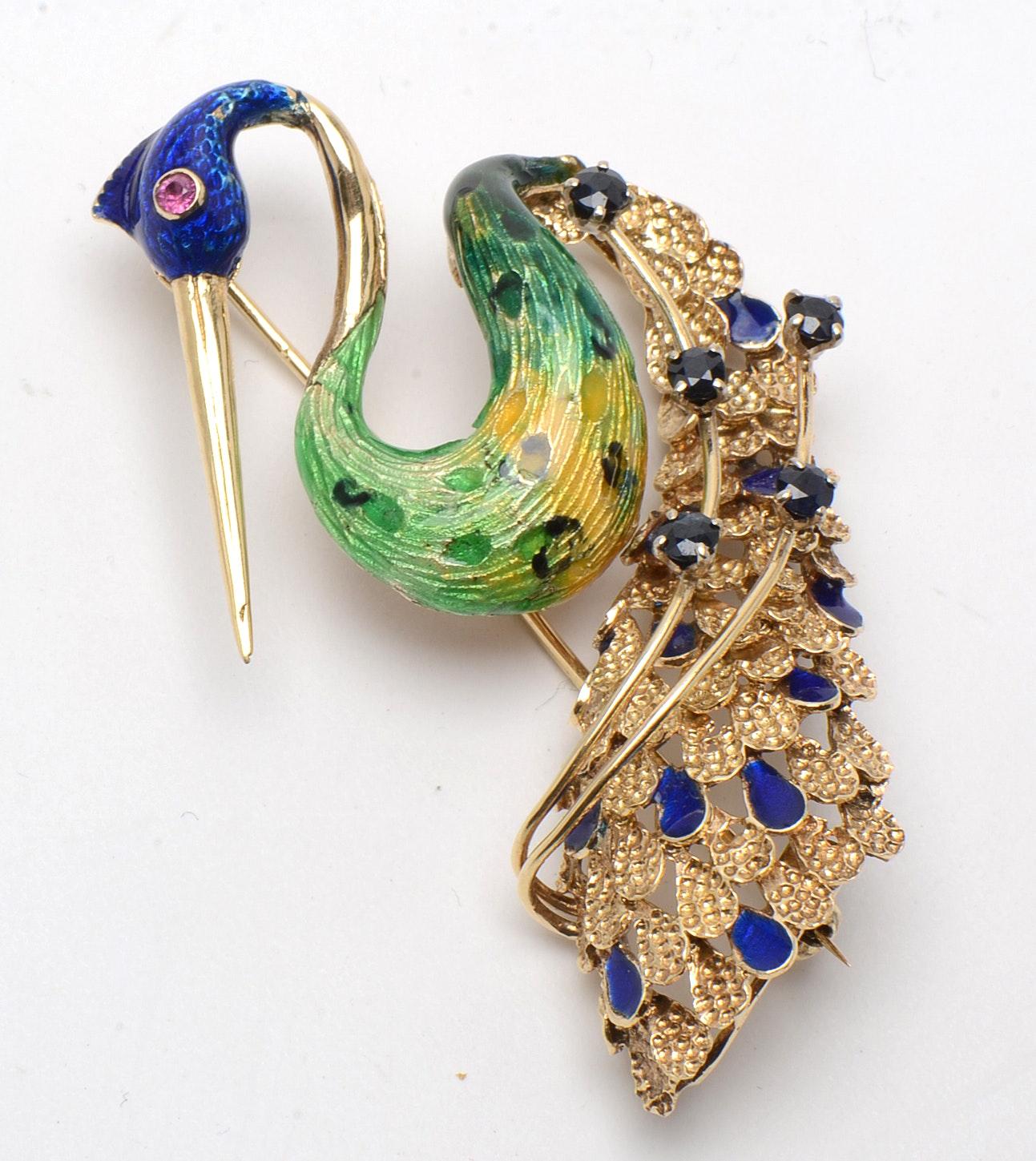 Give your look some retro flair and a pop of color with this amazing 1970's peacock brooch. Crafted of solid 14 karat gold, the peacock has enamel coloring to his head, body, and tail along with a ruby eye and blue sapphires to the tail.

Metal