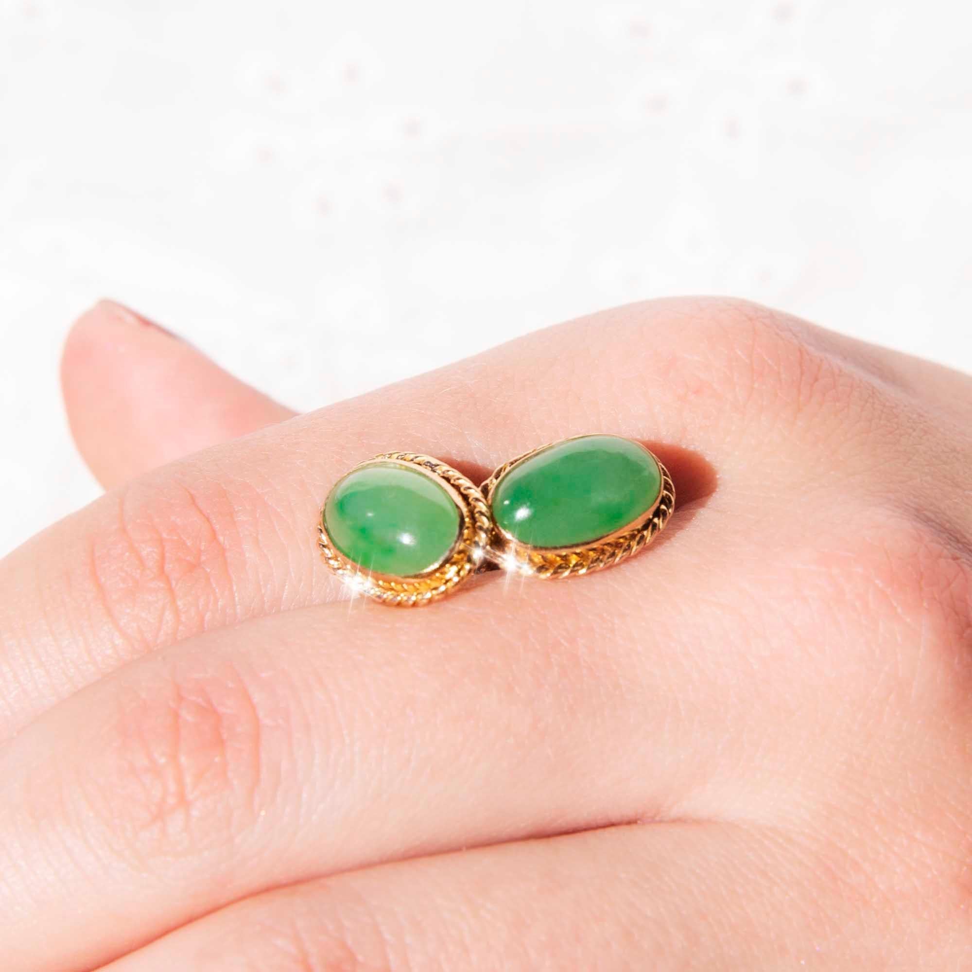 Crafted in 18 carat yellow gold, these opulent vintage earrings each hold one opulent translucent oval jadeite jade cabochon with a rope-textured border. We have named them The Argi Earrings. Fitted with butterfly post backings for simple and