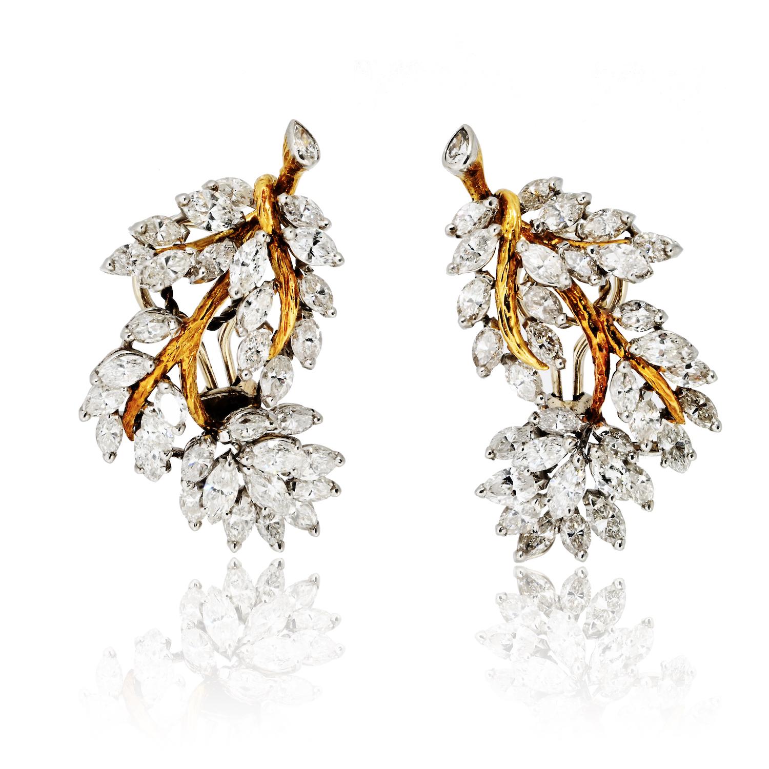 These magnificent estate earrings are a true celebration of vintage glamour and exceptional craftsmanship. Meticulously crafted in platinum and 18K yellow gold, they feature an elegant cluster design reminiscent of delicate leaves. Set with a