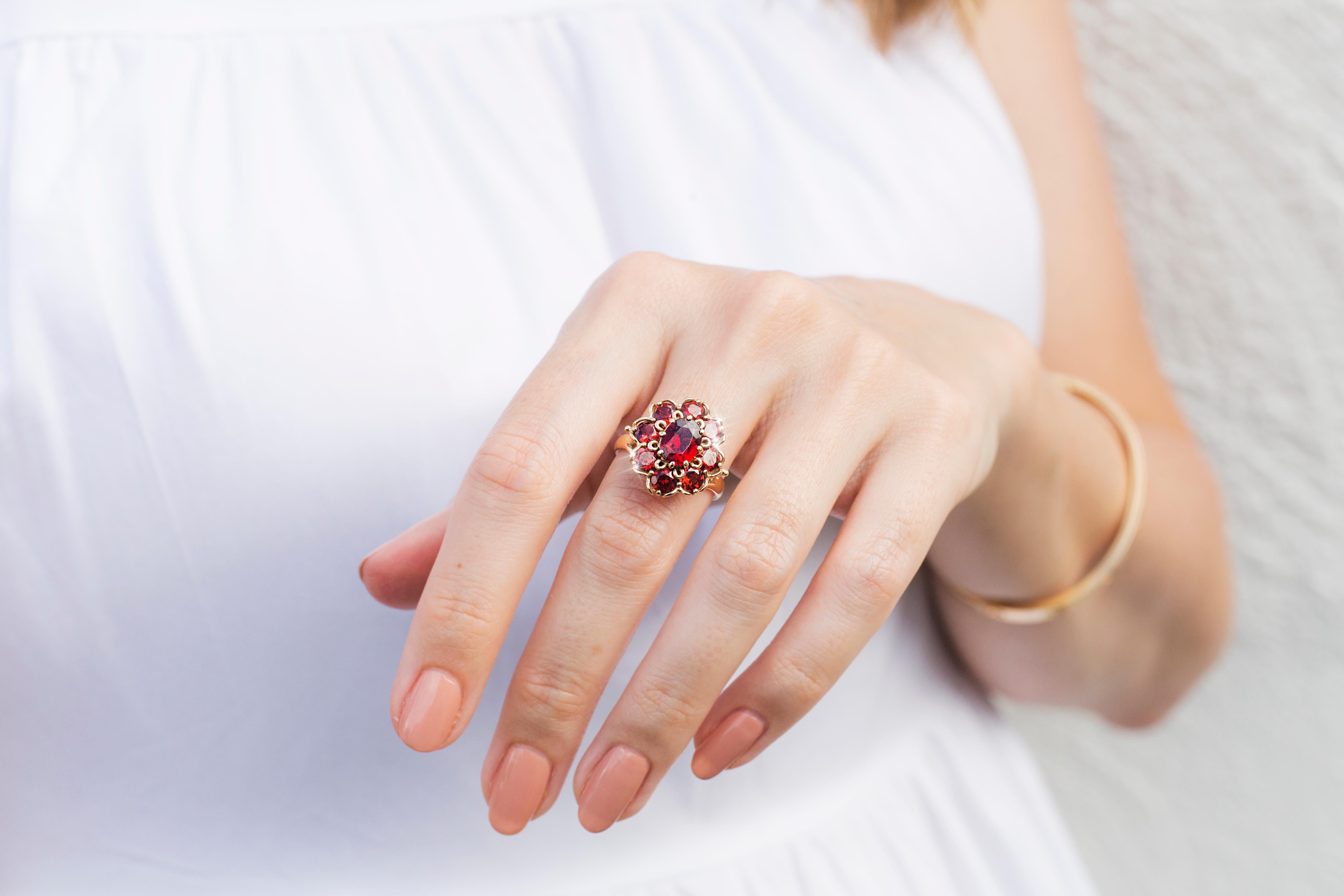 Oval Cut Circa 1970s Red Oval Garnet Vintage Halo Cluster Ring in 9 Carat Yellow Gold