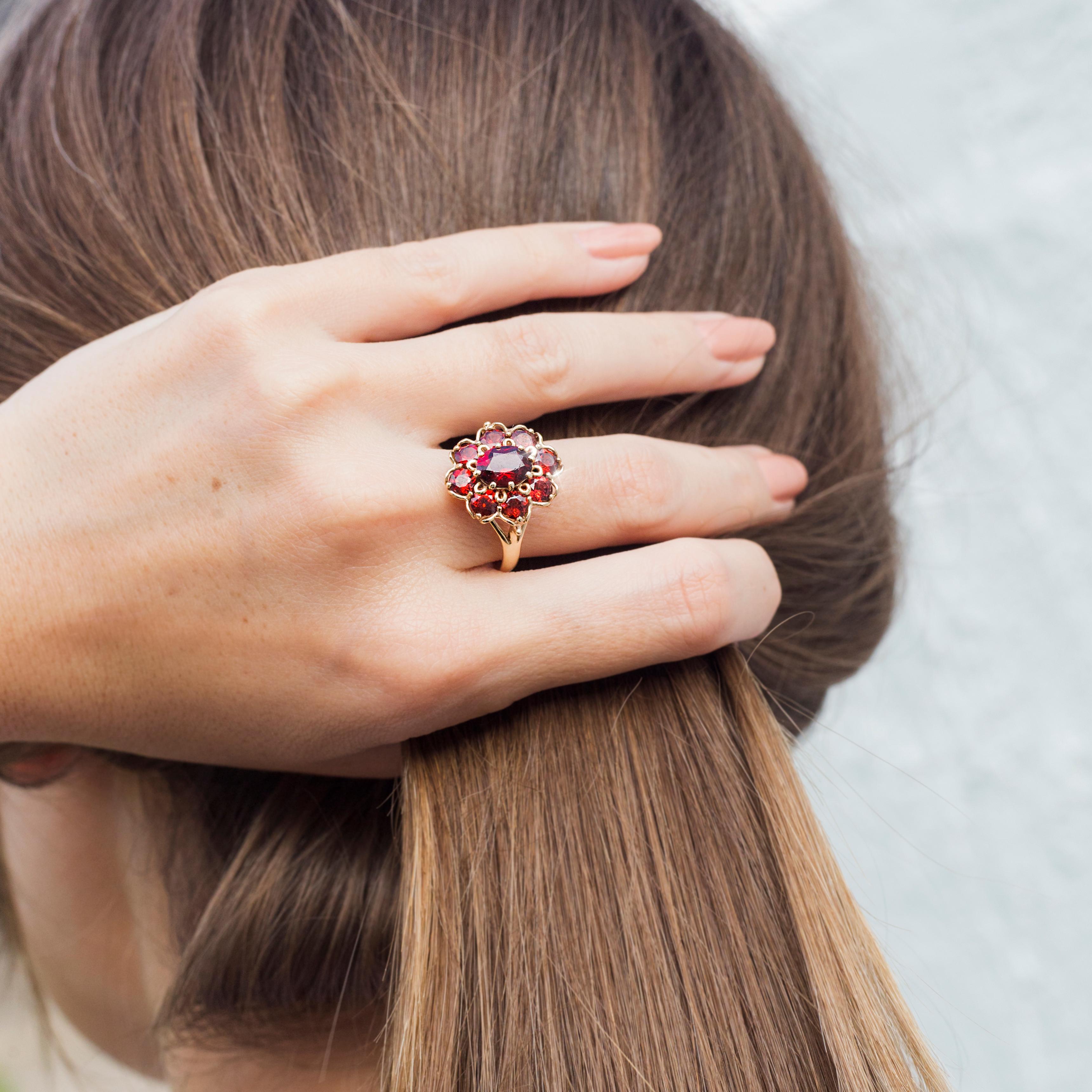 Women's Circa 1970s Red Oval Garnet Vintage Halo Cluster Ring in 9 Carat Yellow Gold