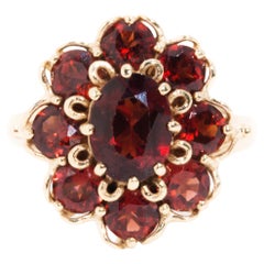 Circa 1970s Red Oval Garnet Vintage Halo Cluster Ring in 9 Carat Yellow Gold