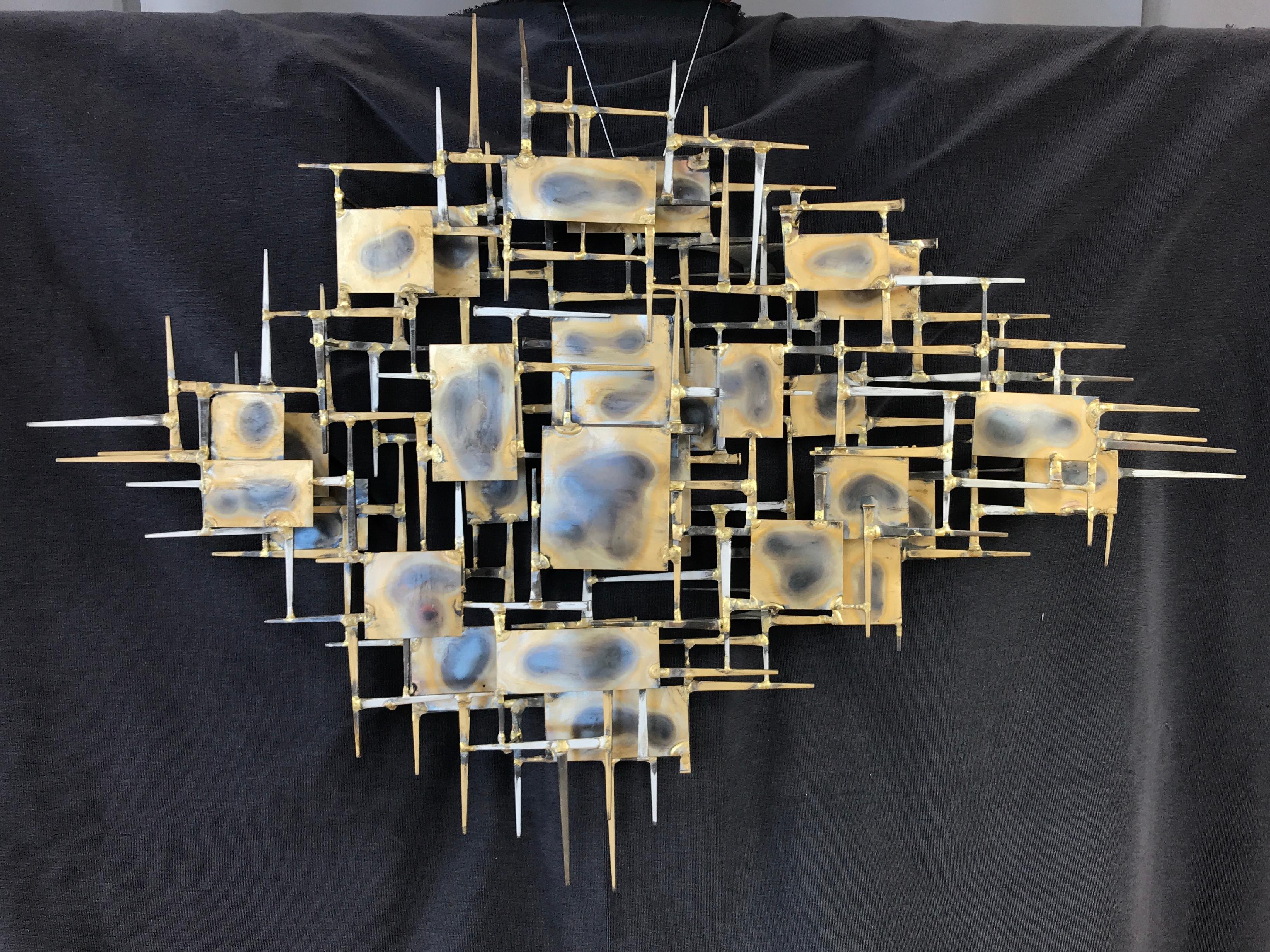 A large brutalist abstract wall sculpture by Marc Creates, circa 1978.
It's made of nails and plates welded and torched, a classic brutalist sculpture.