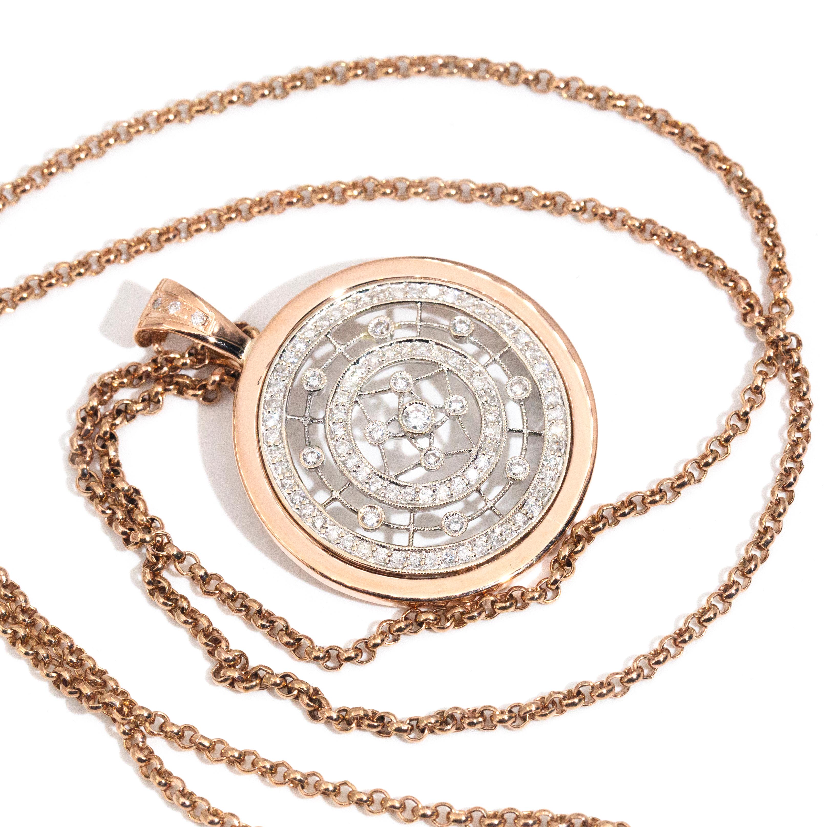 Crafted in 9 carat rose and white gold, this wonderful enhancer pendant features an elegant rose gold circular frame. The frame holds a white gold filigree gallery with two concentric halos of shimmering round brilliant diamonds and additional round