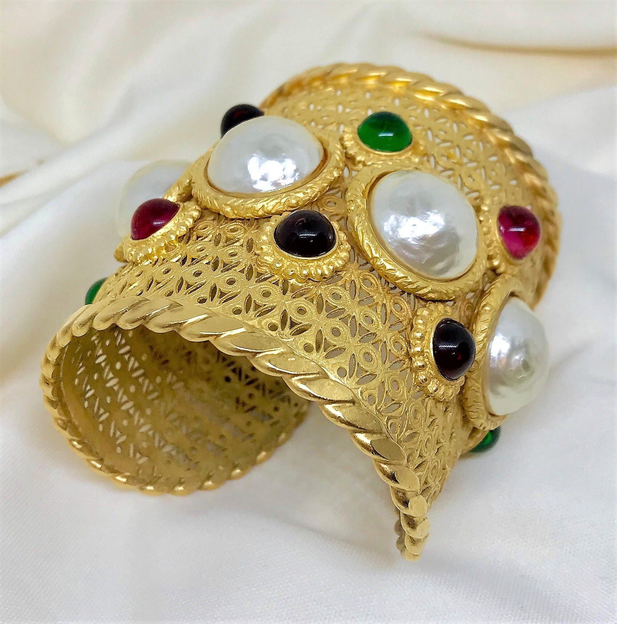 Circa 1980s Deanna Hamro ornate, bright gold-plated brass cuff set with five large textured cabochon-style faux-pearls and embellished with bezel set, multi jewel-tone glass cabochons.  This is a very well made, substantial piece and the overall