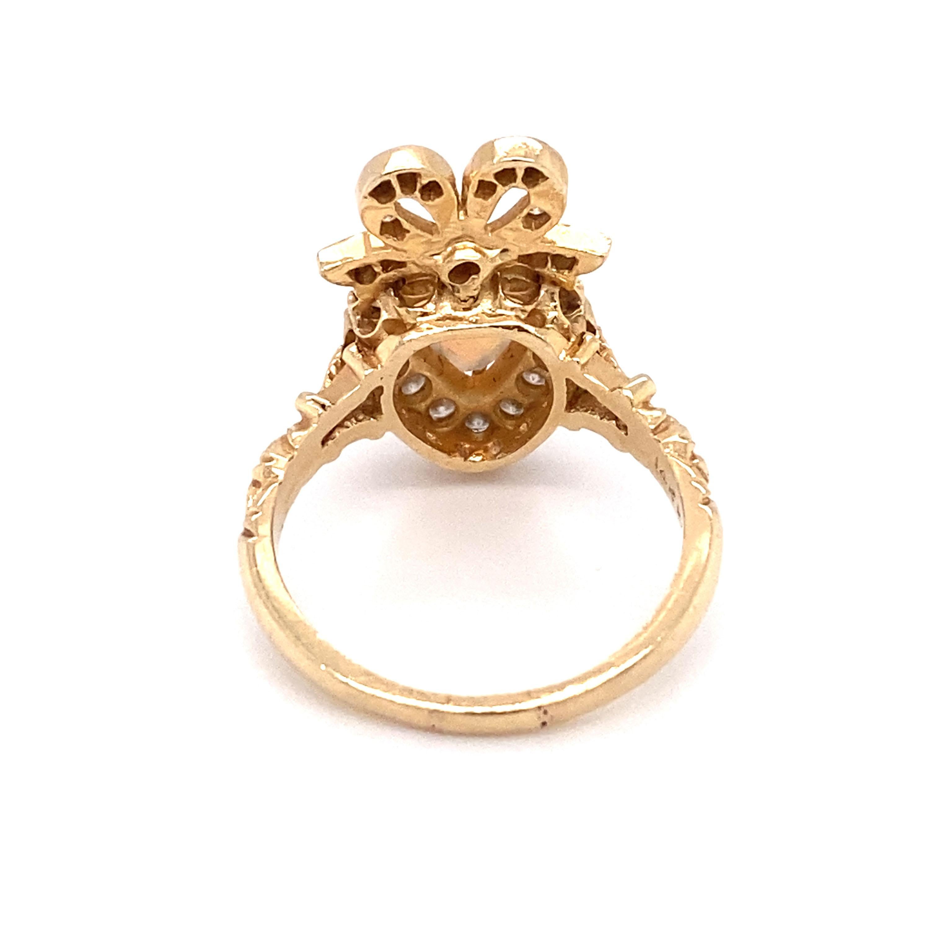 Circa: Circa 1980s
Metal Type: 14 karat yellow gold
Size: US 8.5
Weight: 5.7g

Diamond Details:

Cut: Round
Carat: 1.0 carat total weight
Color: G-H
Clarity: VS-SI

Opal Details:

Cut: Heart
Carat: 0.60 carats