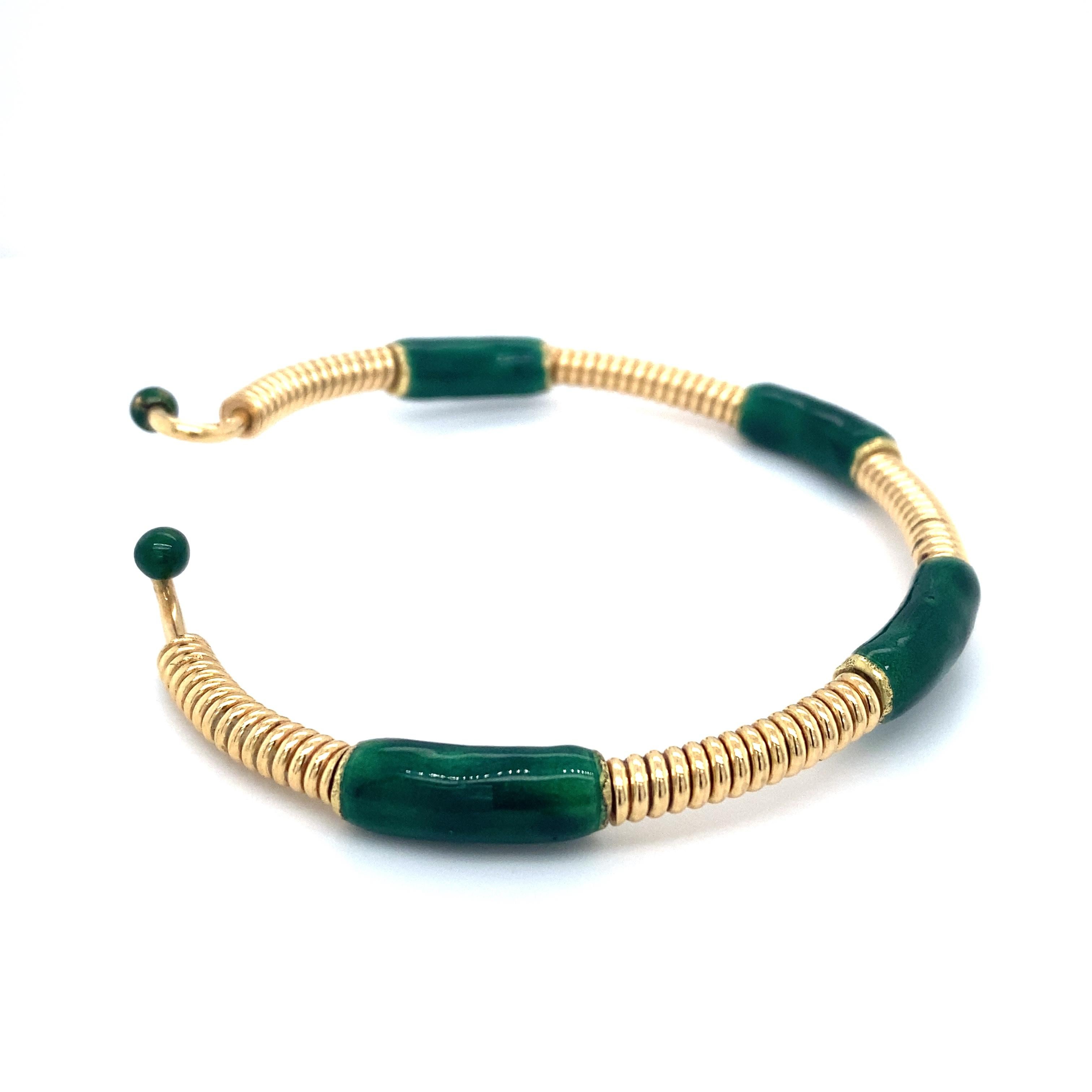 Item Details: This bracelet by GUCCI is stamped with the maker's mark and features a coiled gold and enamel design.

Circa: 1980s
Metal Type: 18 Karat Yellow Gold
Weight: 31.3 grams