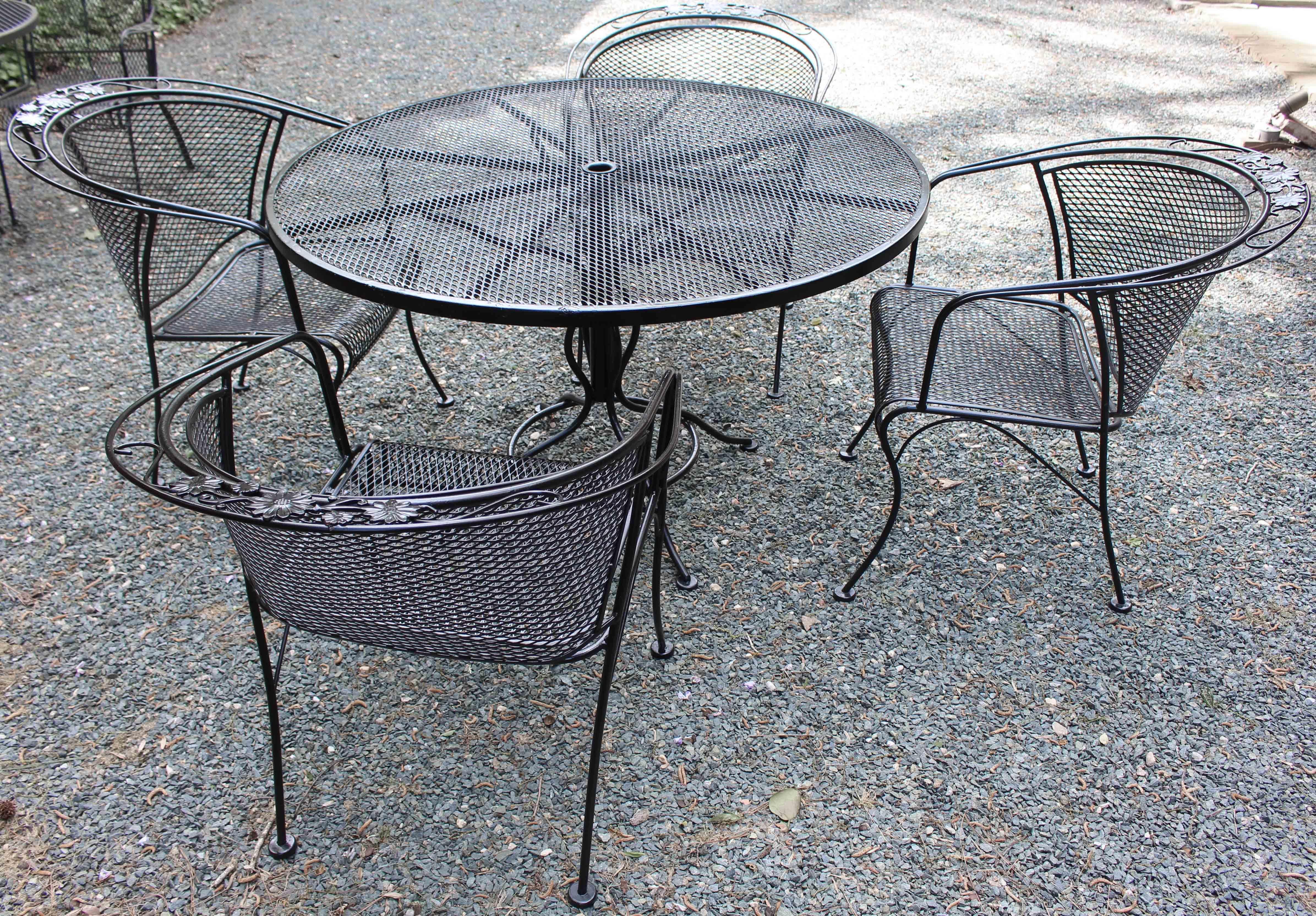 Wrought iron table & 4 chairs by Russell Woodard, circa 1980s. The 