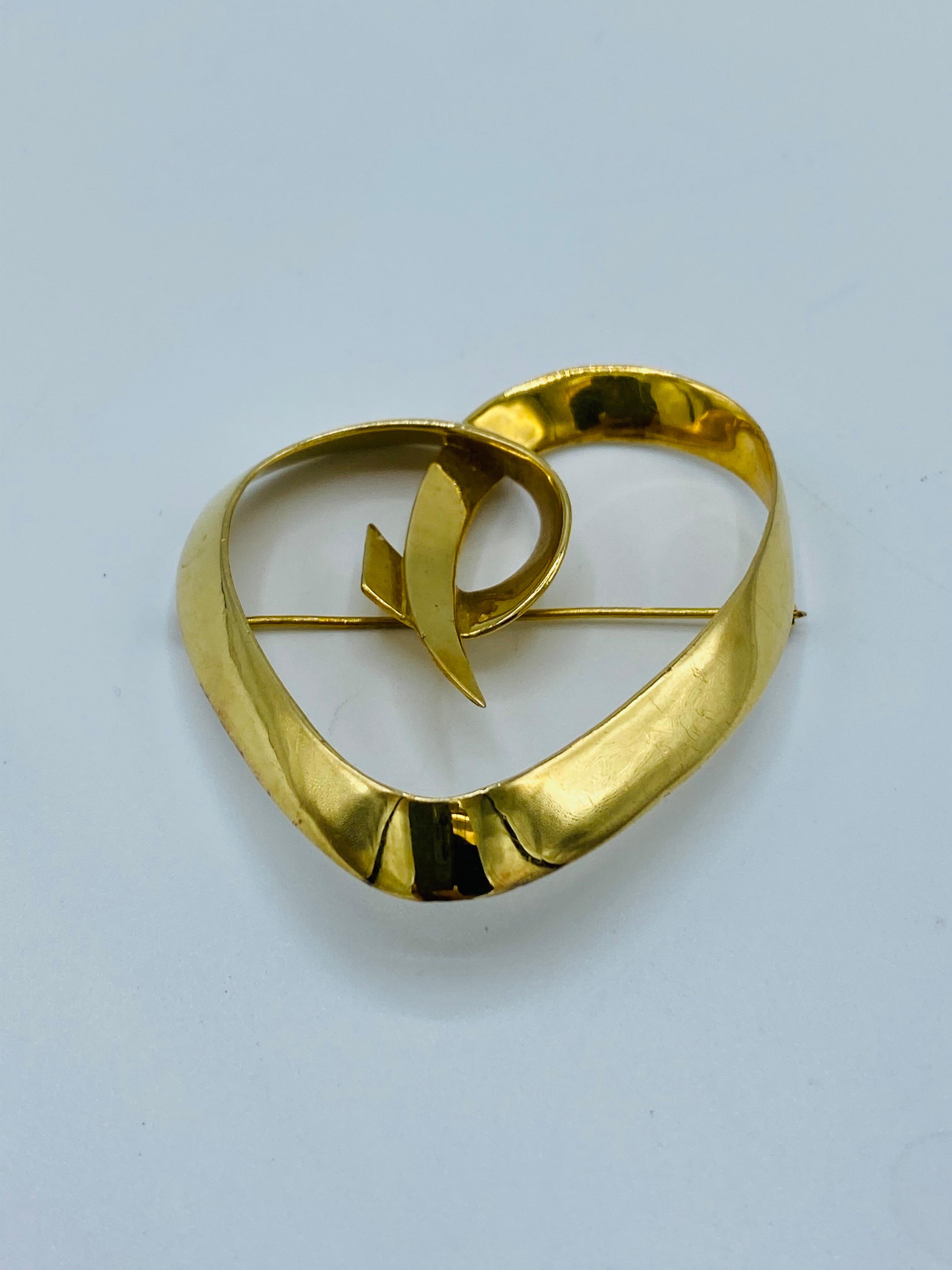 Product details:

The brooch was designed by Paloma Picasso for Tiffany and Company in 1983. It is made out of 18K yellow gold in a heart shape. 
It is signed Tiffany & Co. Paloma Picasso, dated 1983 and stamped 18K.
Must have for collectors and it