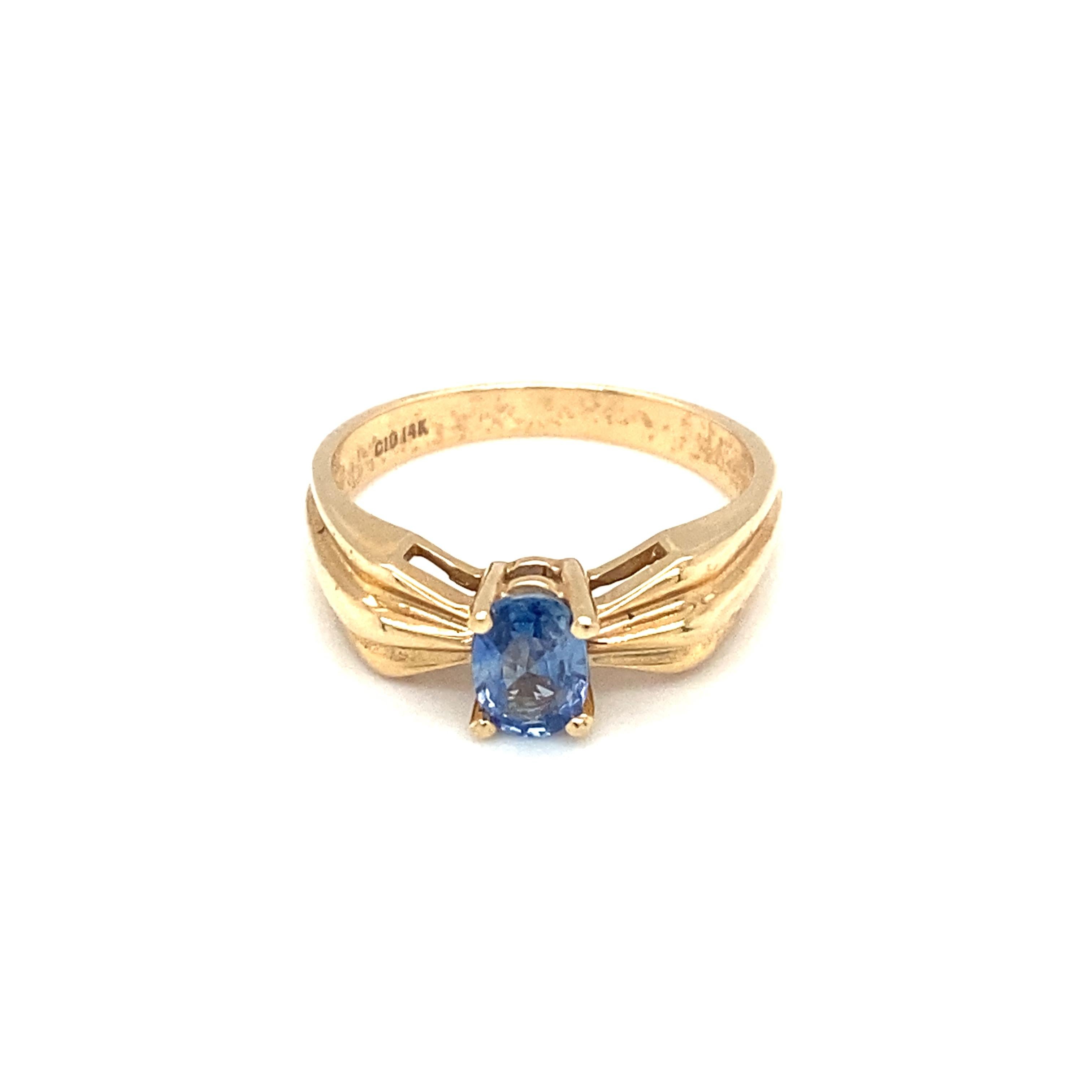 Oval Cut Circa 1990s 0.75 Carat Oval Tanzanite Ring in 14 Karat Yellow Gold For Sale