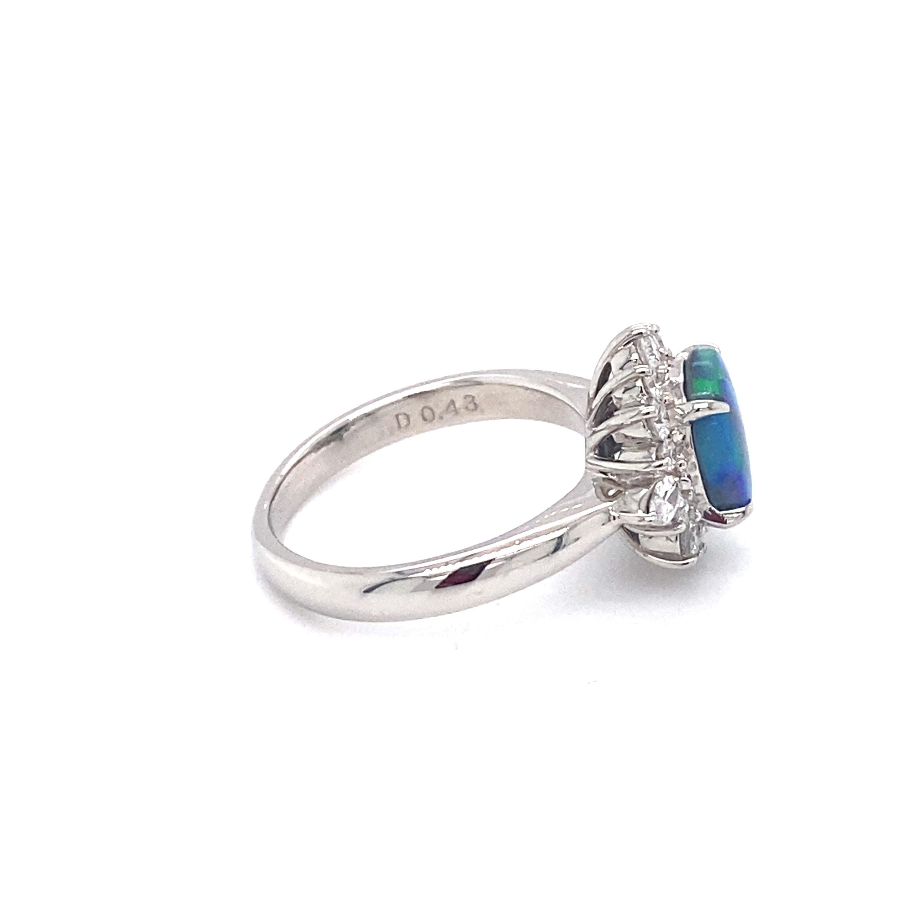 Oval Cut Circa 1990s 0.93 Carat Australian Black Opal and Diamond Ring in Platinum For Sale