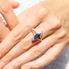 Circa 1990s 14 Carat White Gold Deep Blue Sapphire and Diamond Split Shank Ring