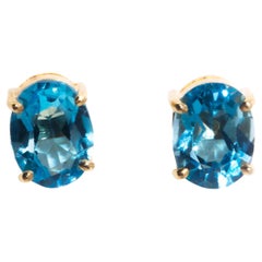 Circa 1990s 9 Carat Yellow Gold Bright Blue Emerald Cut Topaz Stud Earrings