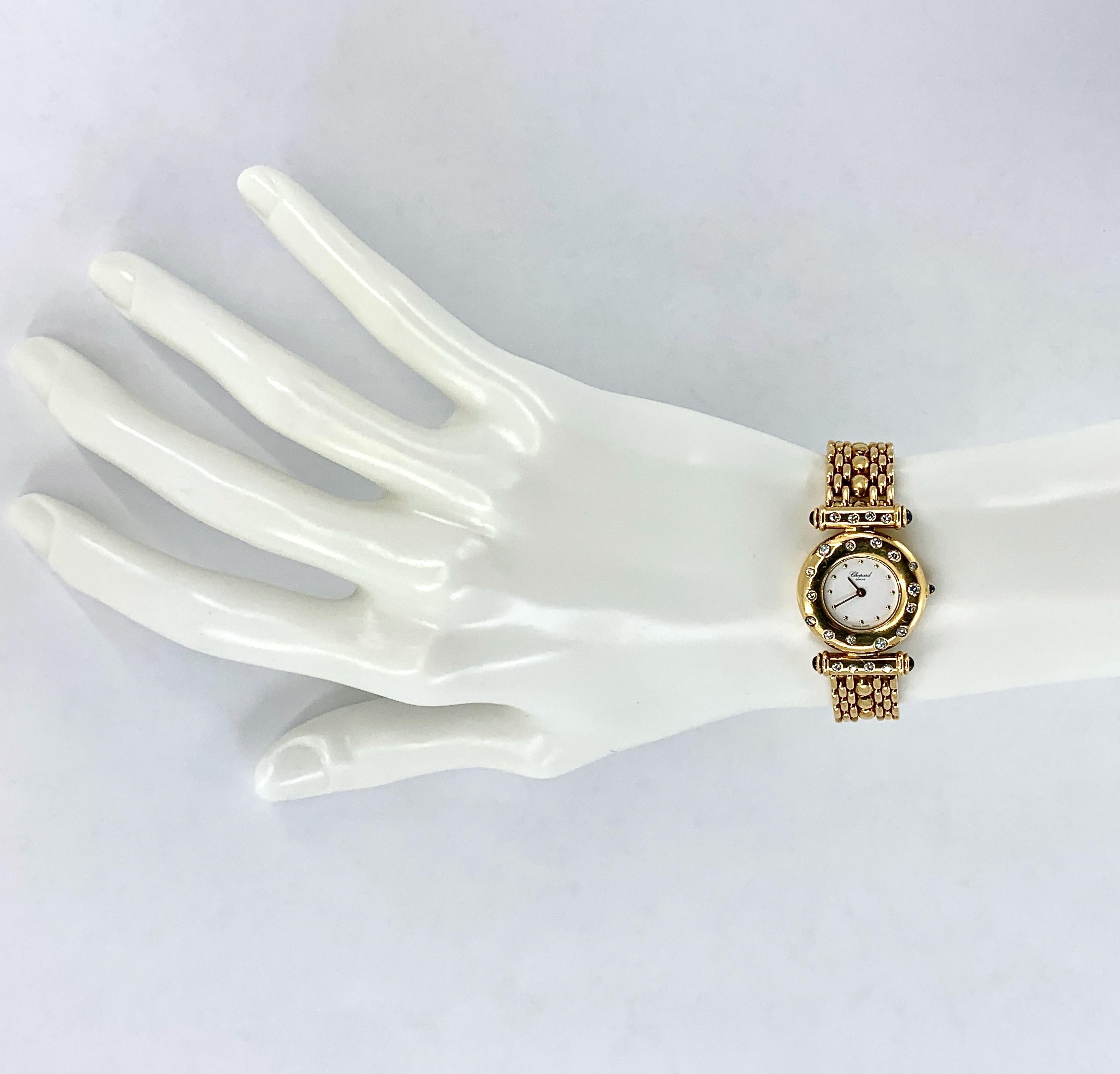 This beautiful, hard-to-find late 20th century timepiece features a round white face with gold dot hours within a wide, rounded bezel punctuated with clean white diamonds.  The Imperiale-style lug bars are also set with diamonds.  The crown and the
