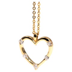 circa 1990s Vintage 18 Carat Gold Tension Set Diamond Heart Pendant with Chain