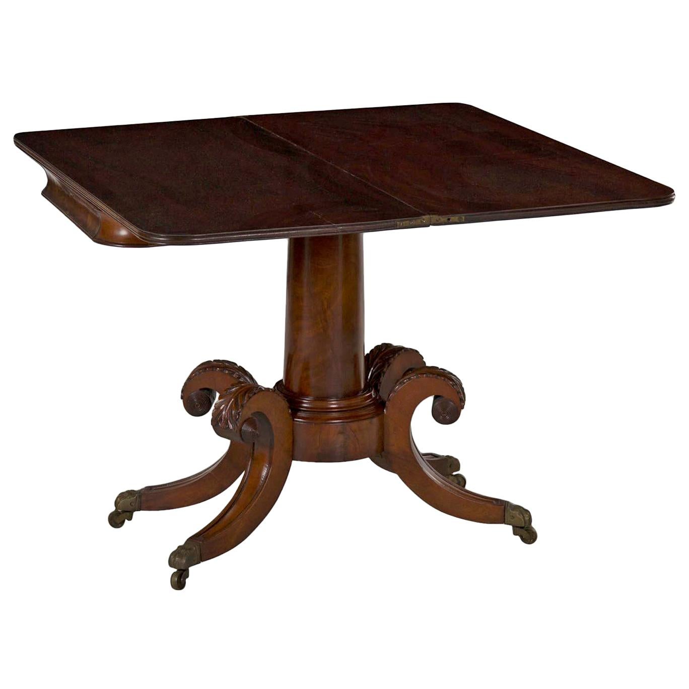 This fine American Classical card table features a pair of full width planks of mahogany with integral molded ends that rotate 90 degrees and flip open on original brass hinges to create a broad card playing surface. Typical of the form, the apron