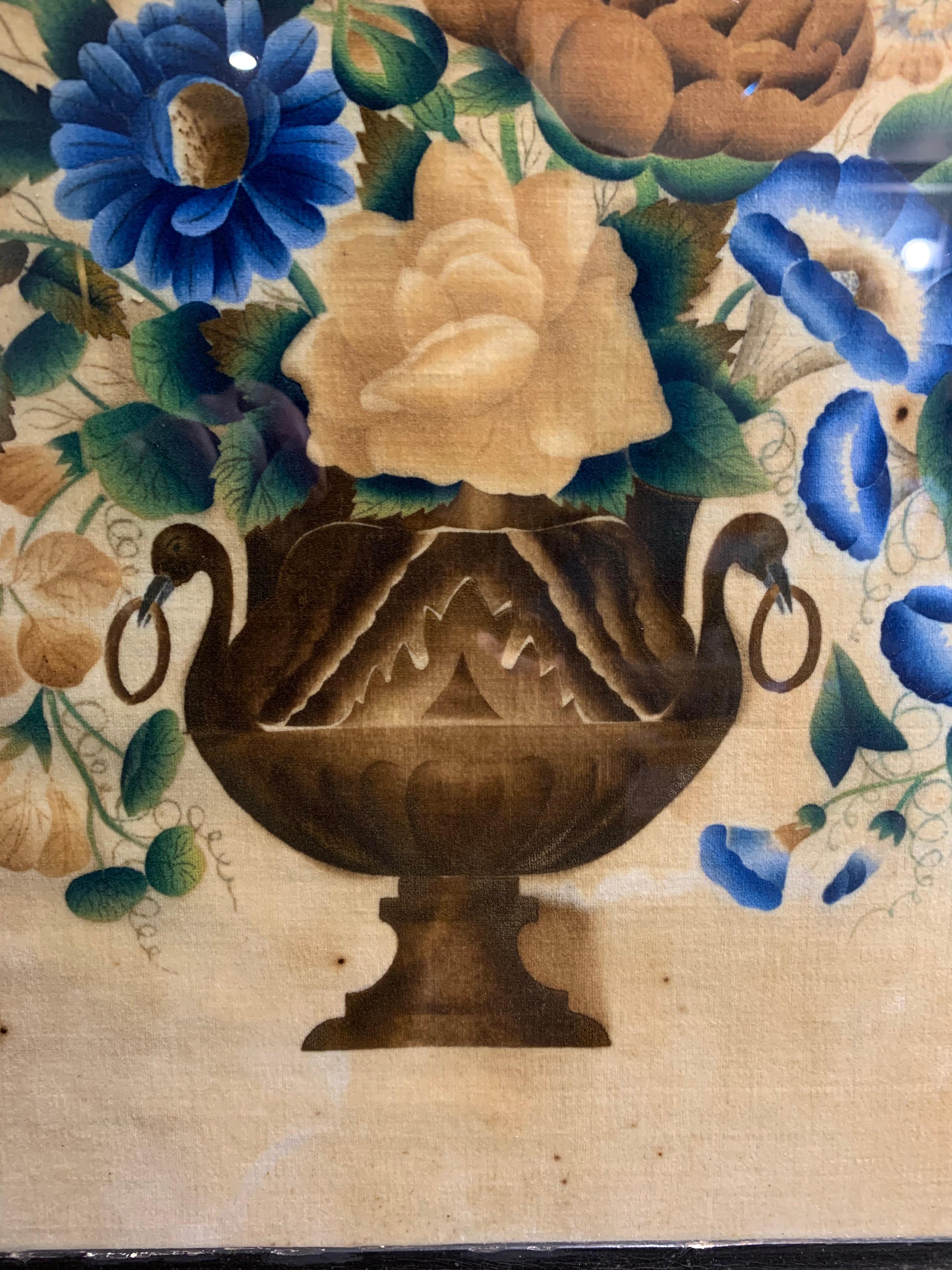 A charming French painting on velvet, circa 1890 of a classical urn full of flowers.
The deep frame is decorated and the flowers are in vibrant blues and muted colours.