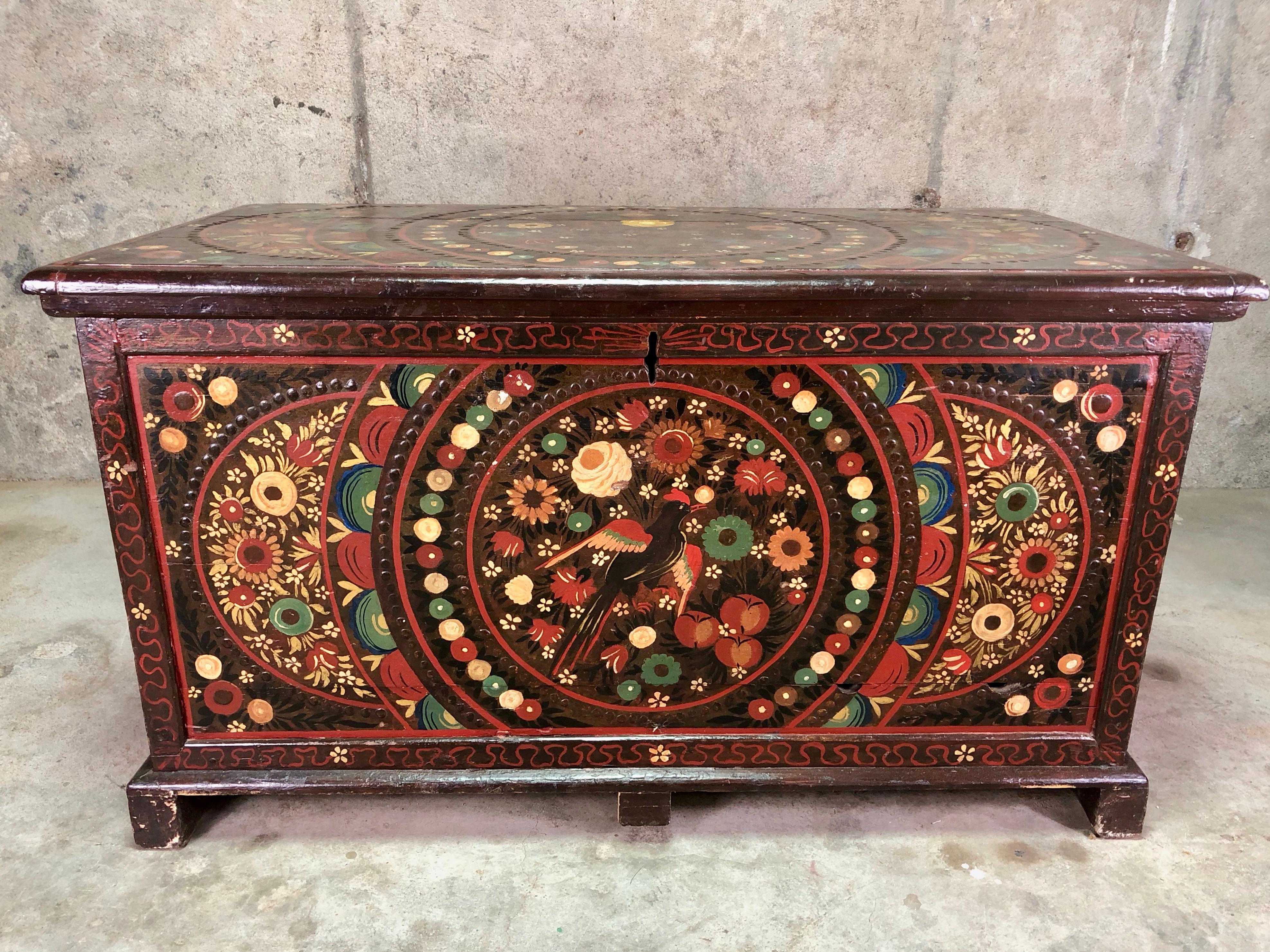 This wonderful French-Alsatian marriage chest, has been hand-painted in a colourful floral design on the top, front and sides, a single bird has been painted into the design on the front of the chest, the back has been left plain.
The top is flat