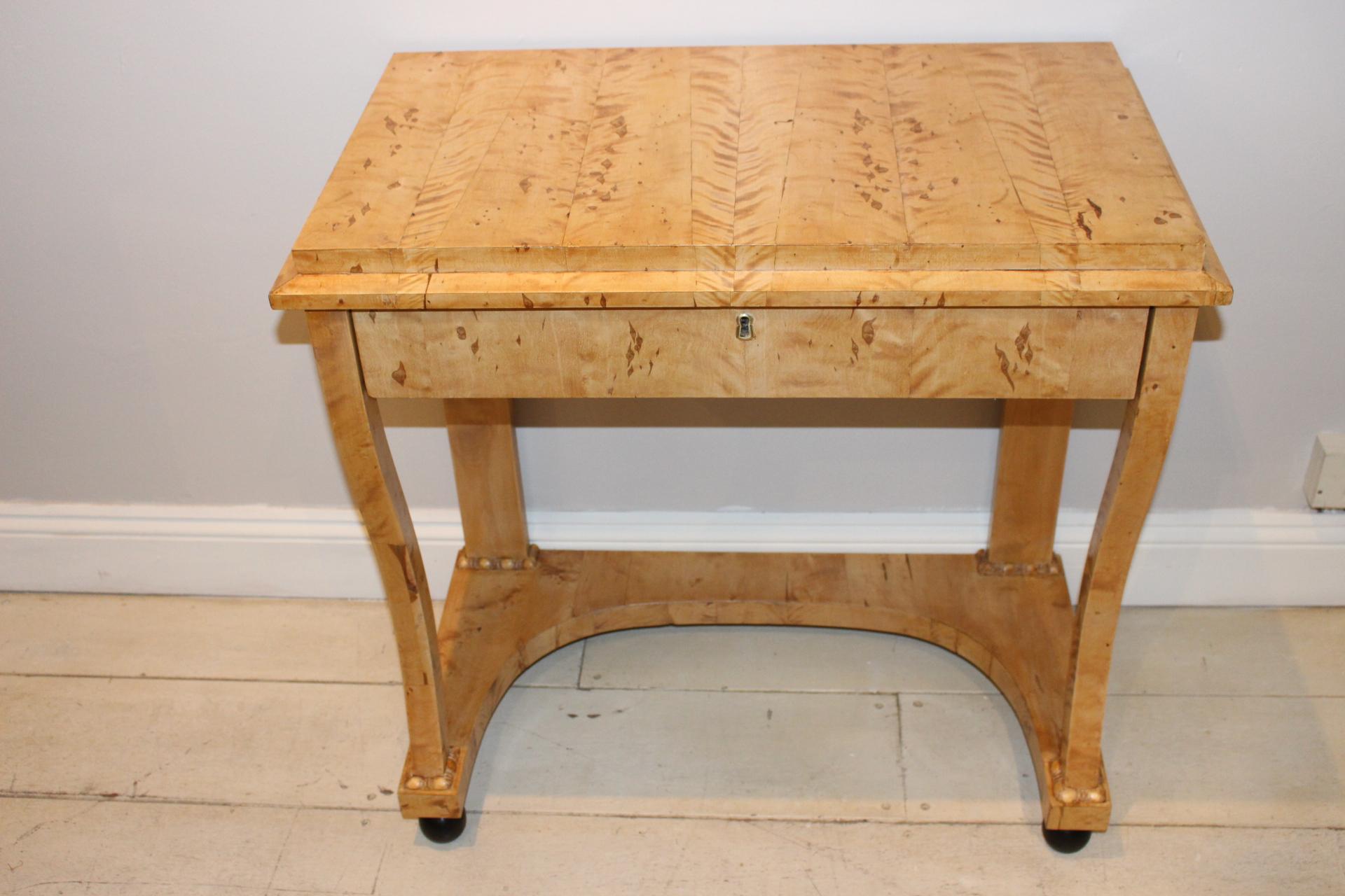 Swedish Birch single drawer console table, circa 19th century. The surface features Tiger like figurations with a golden honey patina There is some subtle detailing where the legs meet the shaped base which stand on ebonised ball feet. Perfect for a