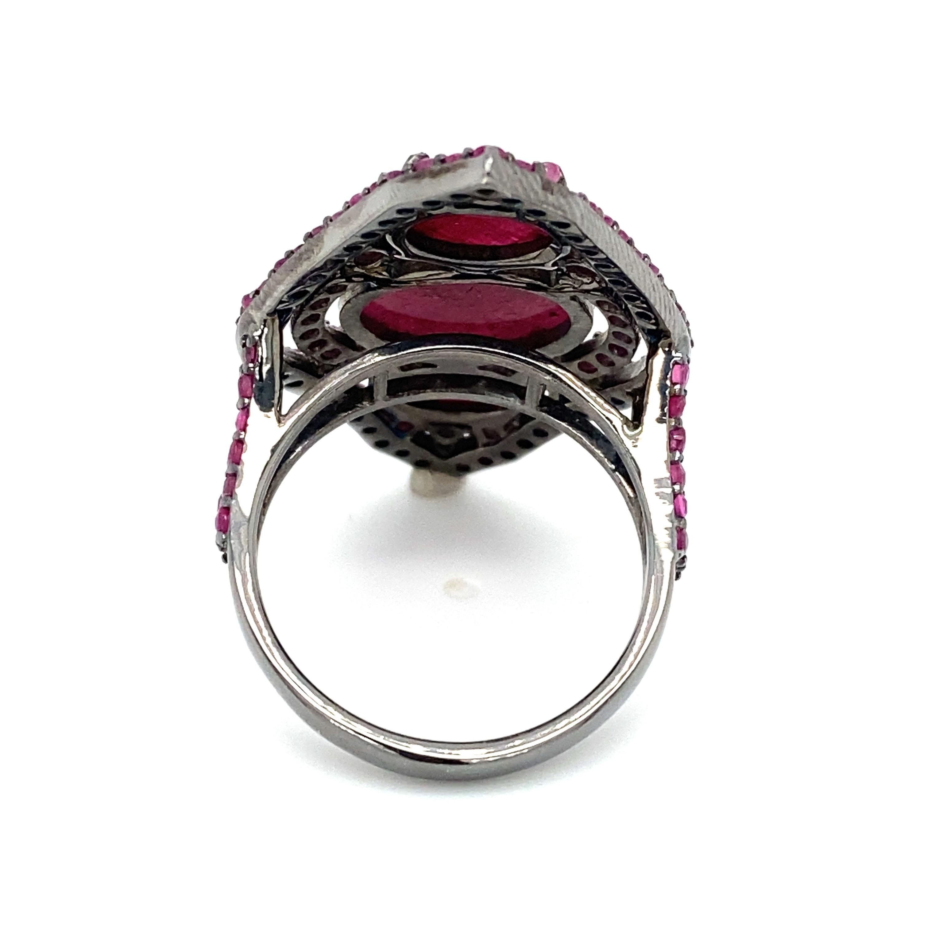Item Details: This ring has five carats of red rubies showing common treatments. Crafted in black rhodium plated sterling silver.

Circa: 2000s
Metal Type: Sterling silver
Weight: 9.3 grams
Size: US 9.25
 