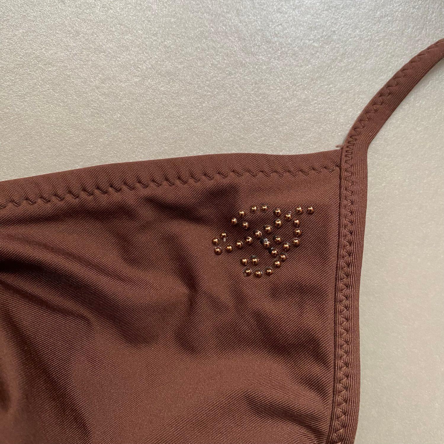 Vintage y2k Blumarine bikini in brown with gemstone ‘B’ for Blumarine detailing. Drawstring style bikini top for adjustable fit and tanga style bikini bottoms. Authenticity label to the inner.

Period
Circa 2000s

Measurements
Label (top): M
Label
