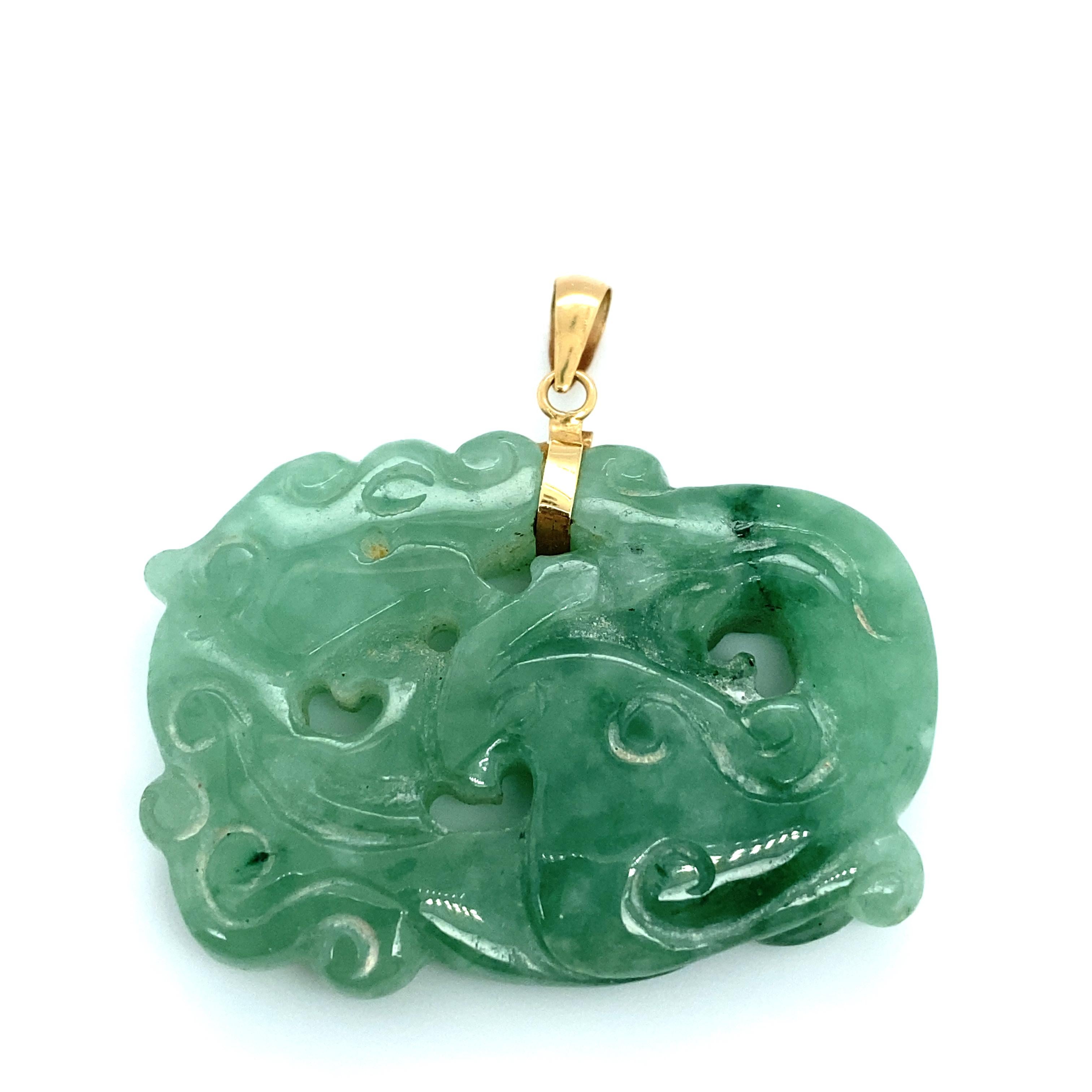Item Details: This Asian carved jade pendant has an intricate design of a dragon with a 14 karat gold bail. The hues of green are absolutely stunning. 

Circa: 2000s
Metal Type:  14 Karat Gold
Weight: 15.2 grams
Size: 1.75 inch Width 
