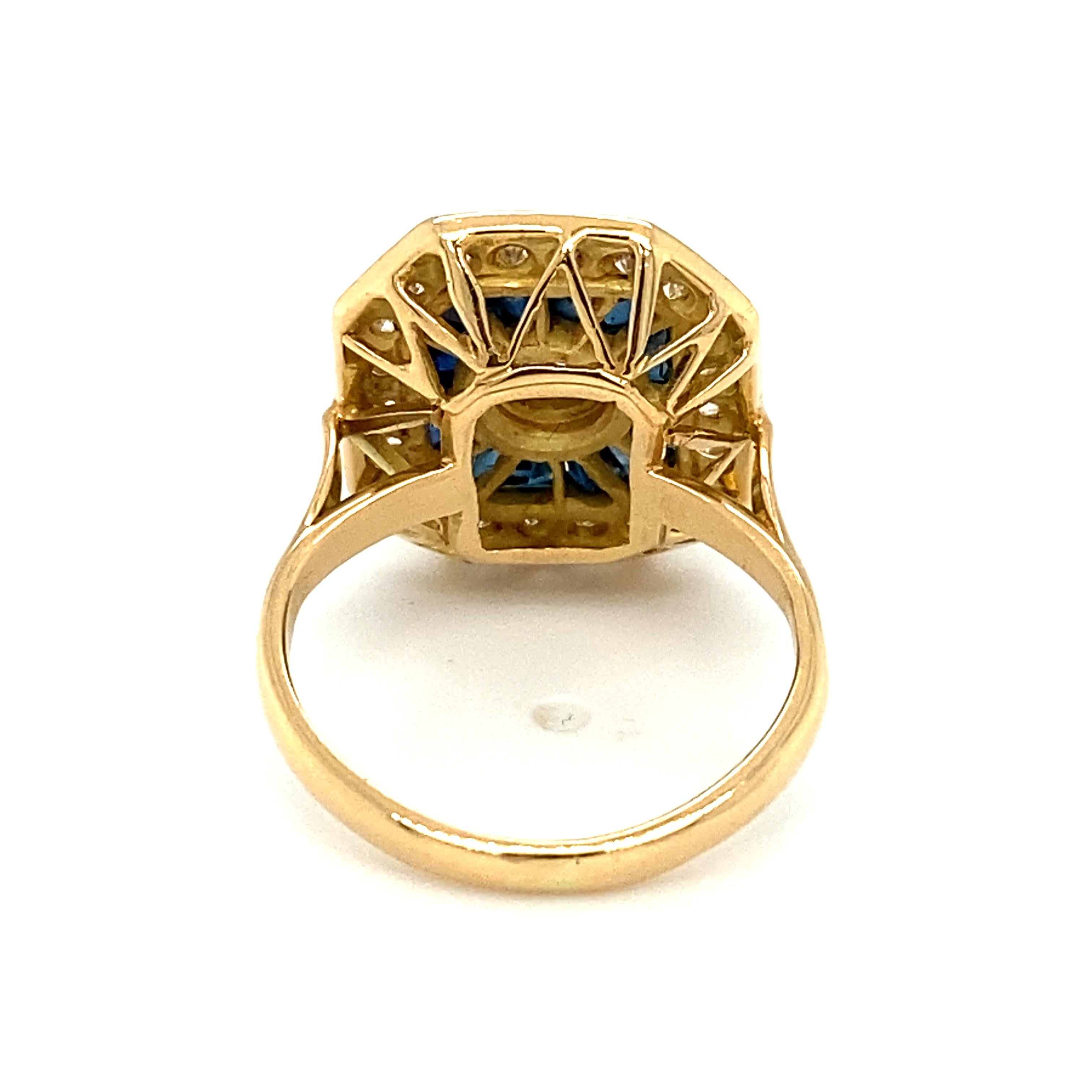 Item Details: This unique ring has a center round diamond in a bezel setting surrounded by sapphires and accent diamonds. It makes for an excellent cocktail or statement ring!

Circa: 2000s
Metal Type: 18 Karat gold
Weight: 5.5 grams
Size: US 4.25,
