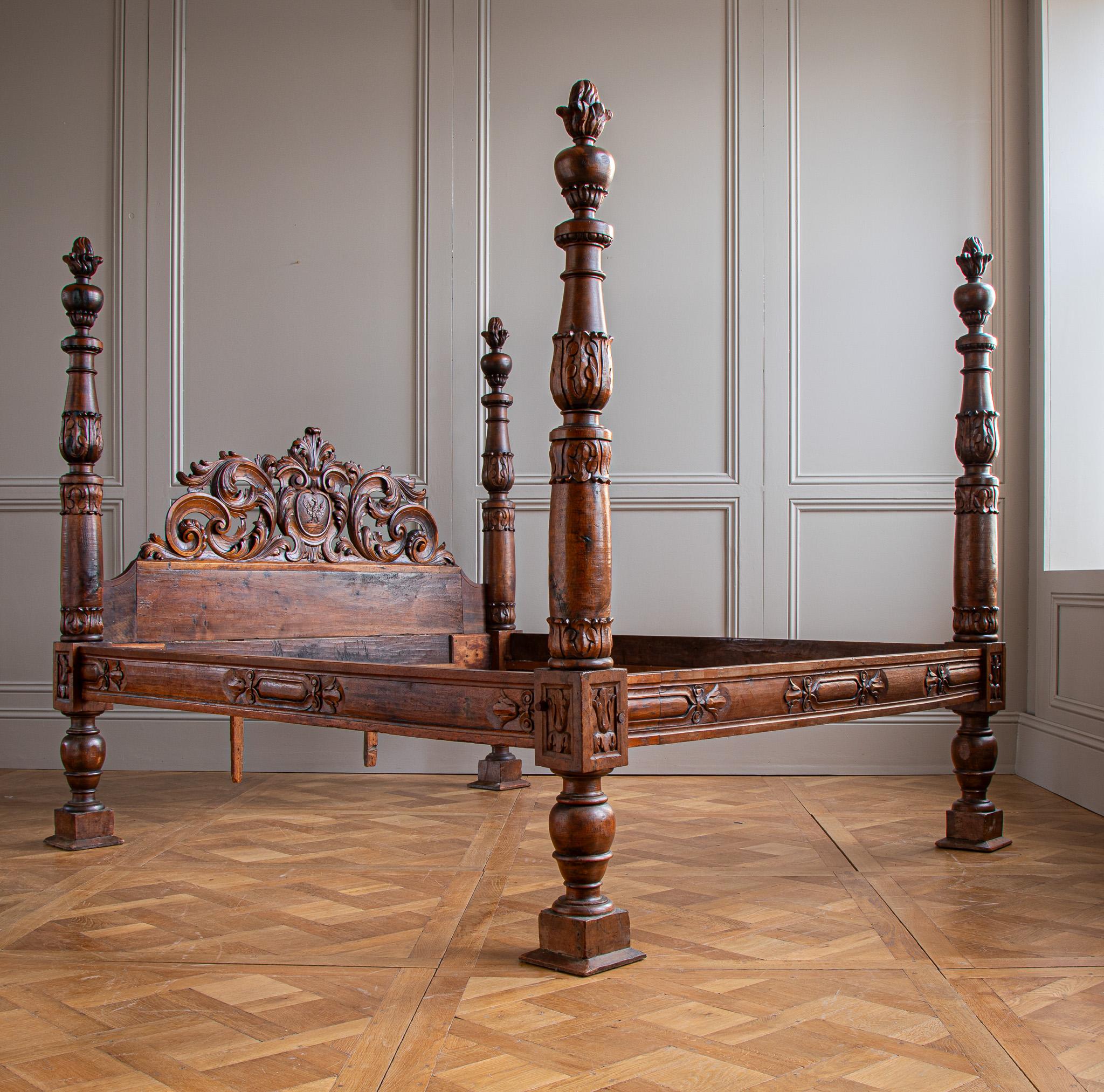 Circa mid 1800's, An impressive four poster bed from Northern Italy in the Baroque style. The bedstead, carved in walnut, has a beautiful deep sheen with natural warm highlights on many of the carved sections. The set of four hand-turned columns are