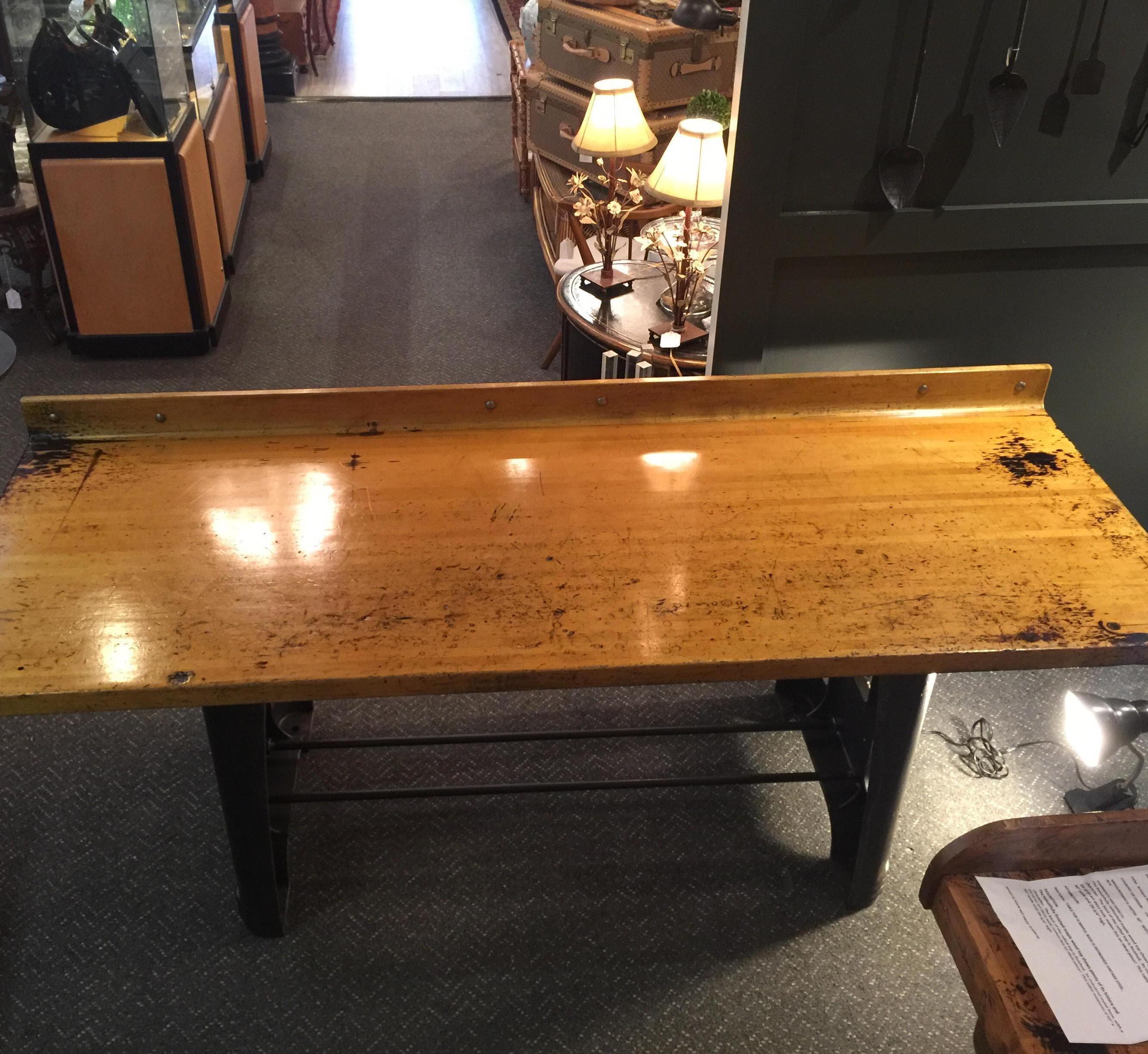 Maple table with refinished vintage steel base, Industrial style, circa mid-1900s
The beautifully refinished maple wood top shows plenty of its history and character. The back of the rolled top is finished. Its Industrial metal base, with a bit of