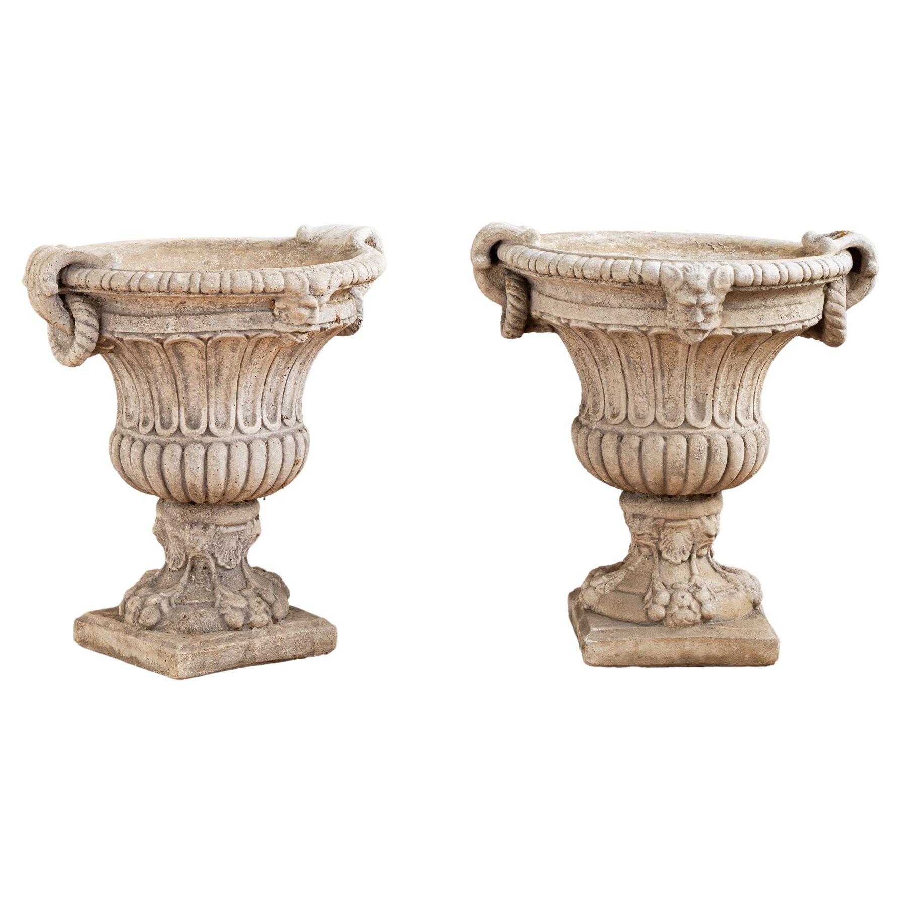 Circa mid 1900's, a matching set of four garden planter urns from Tuscany, Italy. The urns are made from reconstituted stone with lovely decorative detailing, including: fluted body work, egg and dart mouldings, stylised acanthus leaf handles with