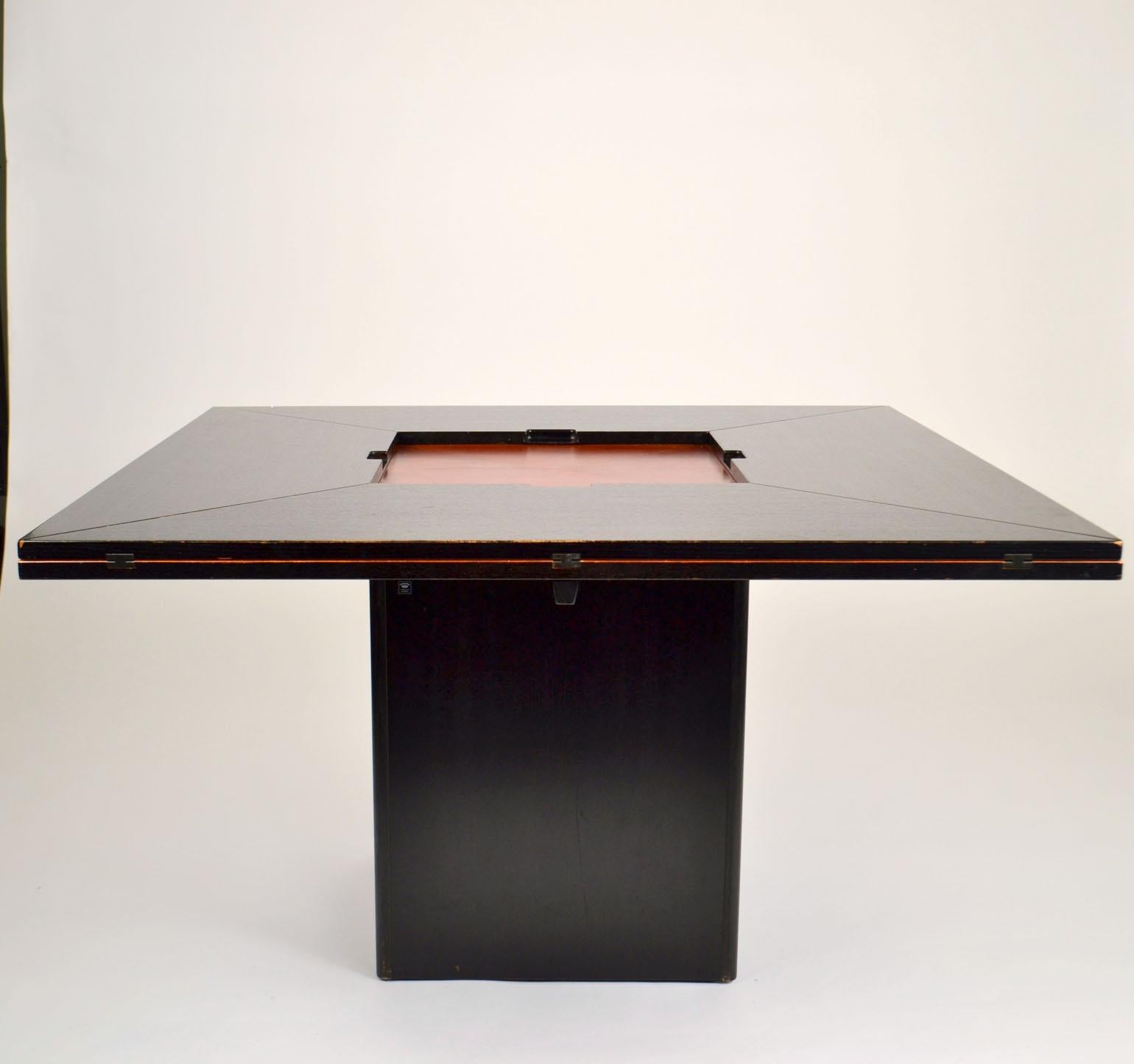 Extendable Cirkante dining table by Pauvers van den Berghe, Belgium and produced by Tranekaer Denmark. The table in compact for is black ebonised wood and measures 145 x 145 cm and seats 4-8 people. The center holds a square slate plate that can be