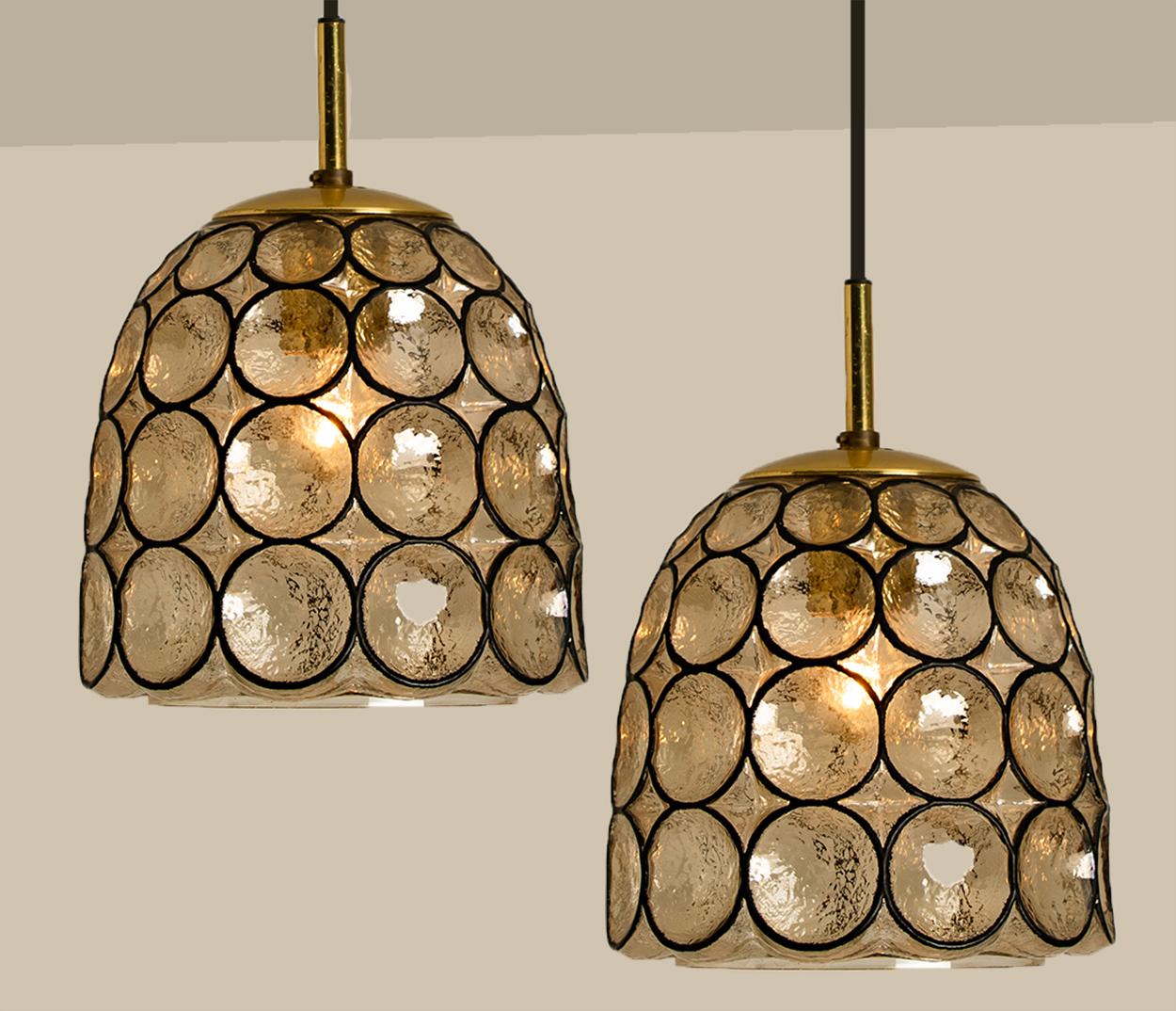 Minimal, geometric and simply shaped design. This beautiful and unique pair of hand blown glass chandeliers/pedant lights were manufactured by Glashütte Limburg in Germany during the 1970s (late 1960s or early 1970s). Beautiful craftsmanship. These