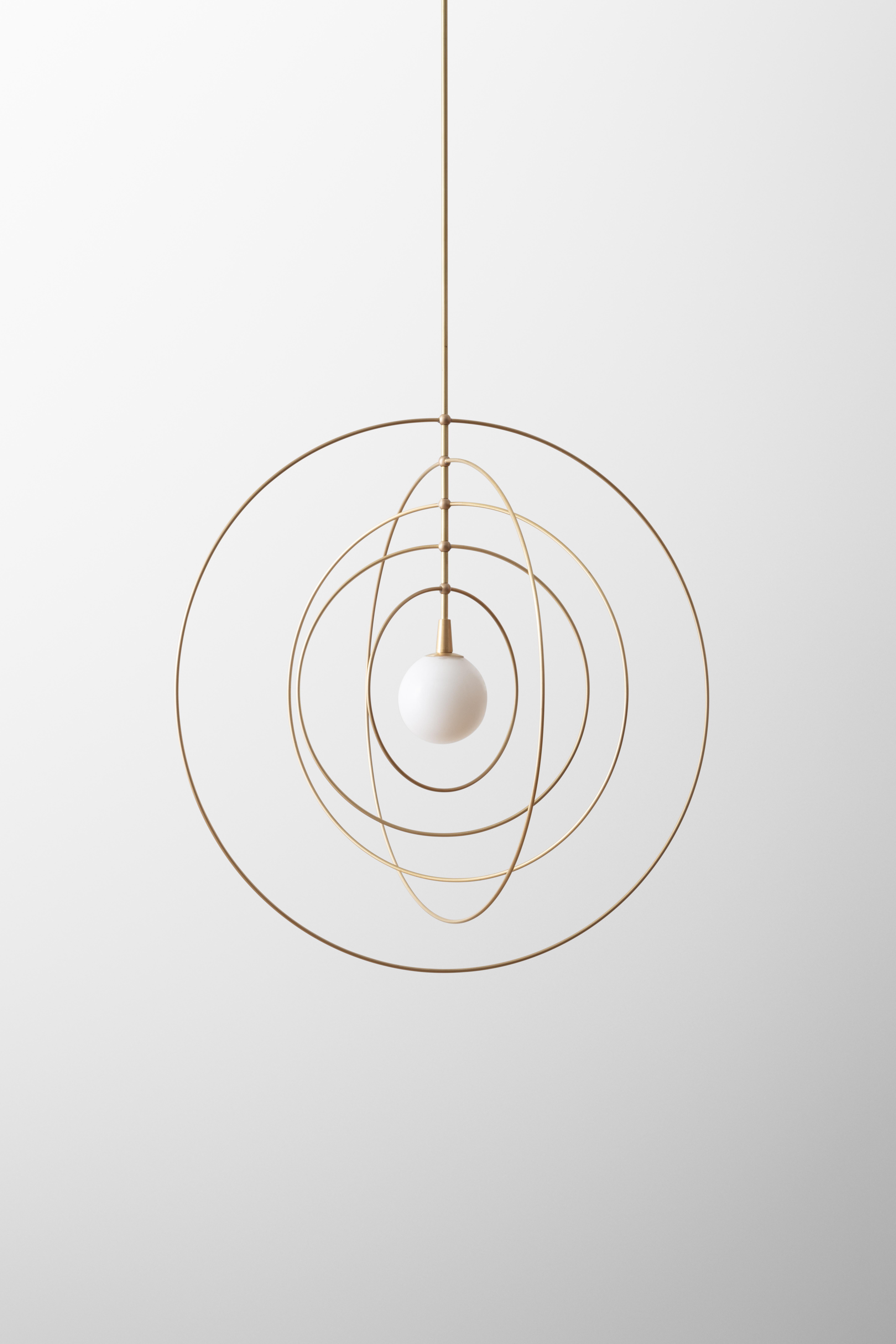 The Mobile series combine sculpture with lighting, invoking motifs from atomic models and the space age. The concentric rings can be spun and reconfigured, inviting play and whimsy. A central orb illuminates the brass rings, which are hand-finished