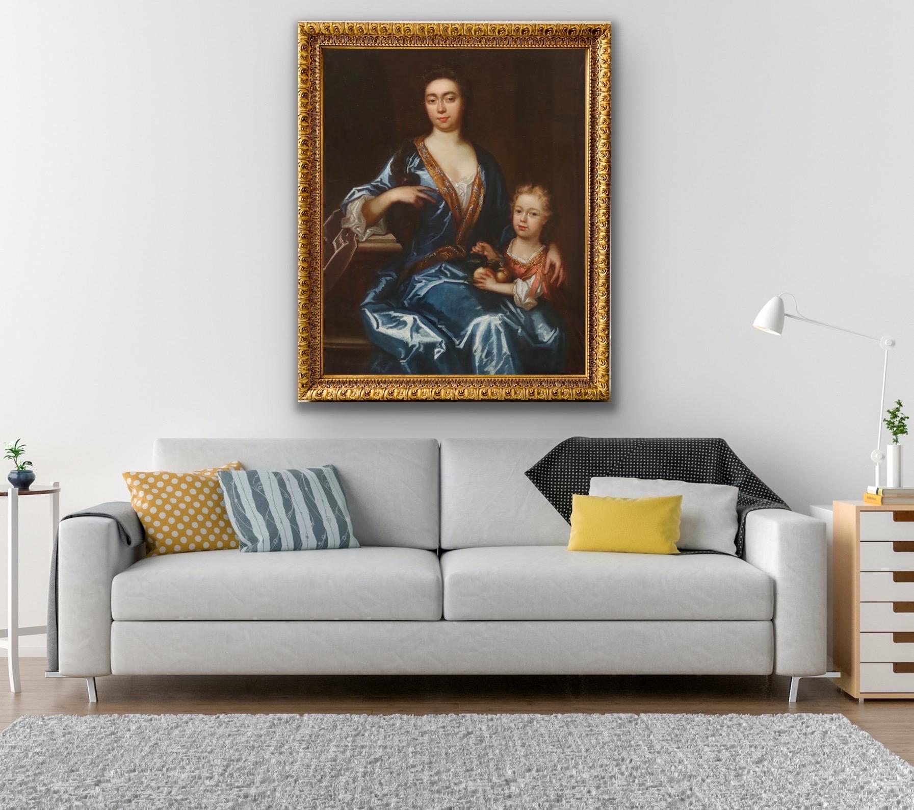 Huge 17th century English portrait of a mother and her son

The very fine and large portrait depicts a mother and her son The Lady is seated in an interior wearing a shimmering blue silk dress with a gilt brocade lining and is resting her arm on a