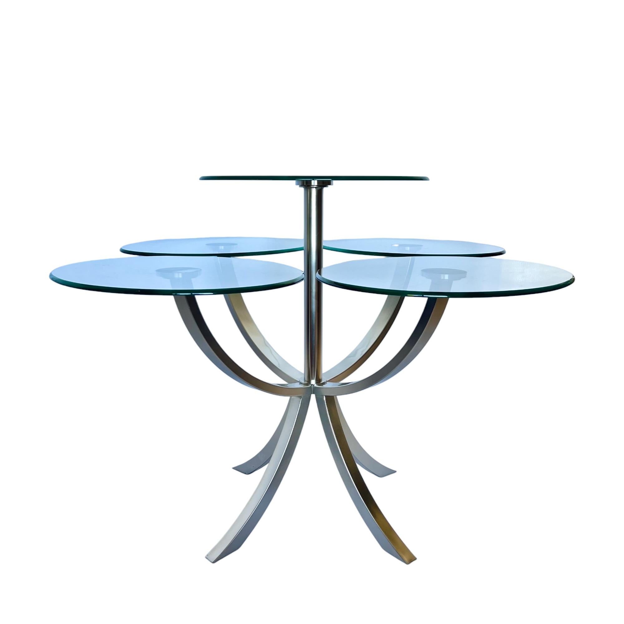 A 'Circle of Life' dining table by the Design Institute of America - DIA, circa 1980. The unique postmodern design showcases four individual table height oval glass dining surfaces surrounding one taller circular center surface. The glass discs are