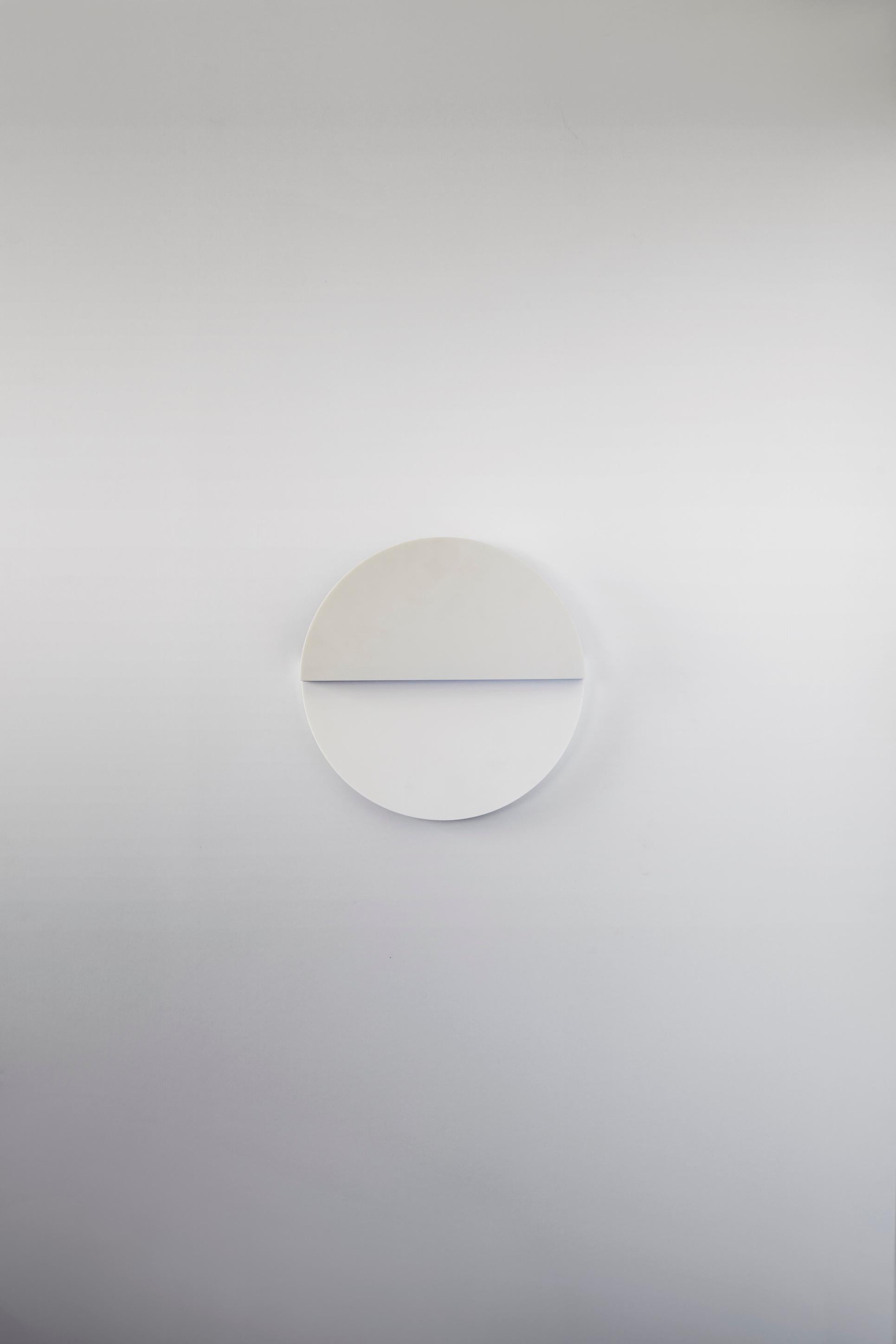 Part of the Cycladic Series, exploring the power of architecture brought to small scale. The circle sconce illuminates the purity, symbolism and intimate power of the circle: one of the most emblematic, elemental geometric forms expressed in both