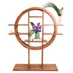Circle-shaped book shelf/room divider in tropical wood