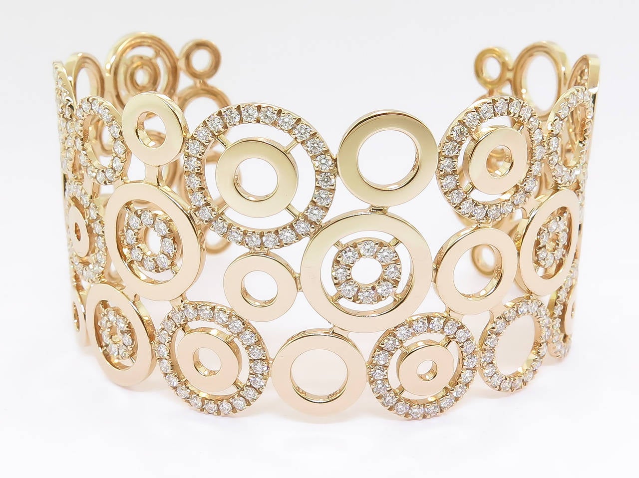 Magnificent design...Circles all over the cuff bracelet with multiple Diamond circles alternating inside and out making this bracelet open and airy.  
Beautifully handcrafted in Italy, utilizing 18k rose gold, and adorned with 3.70 carats of white
