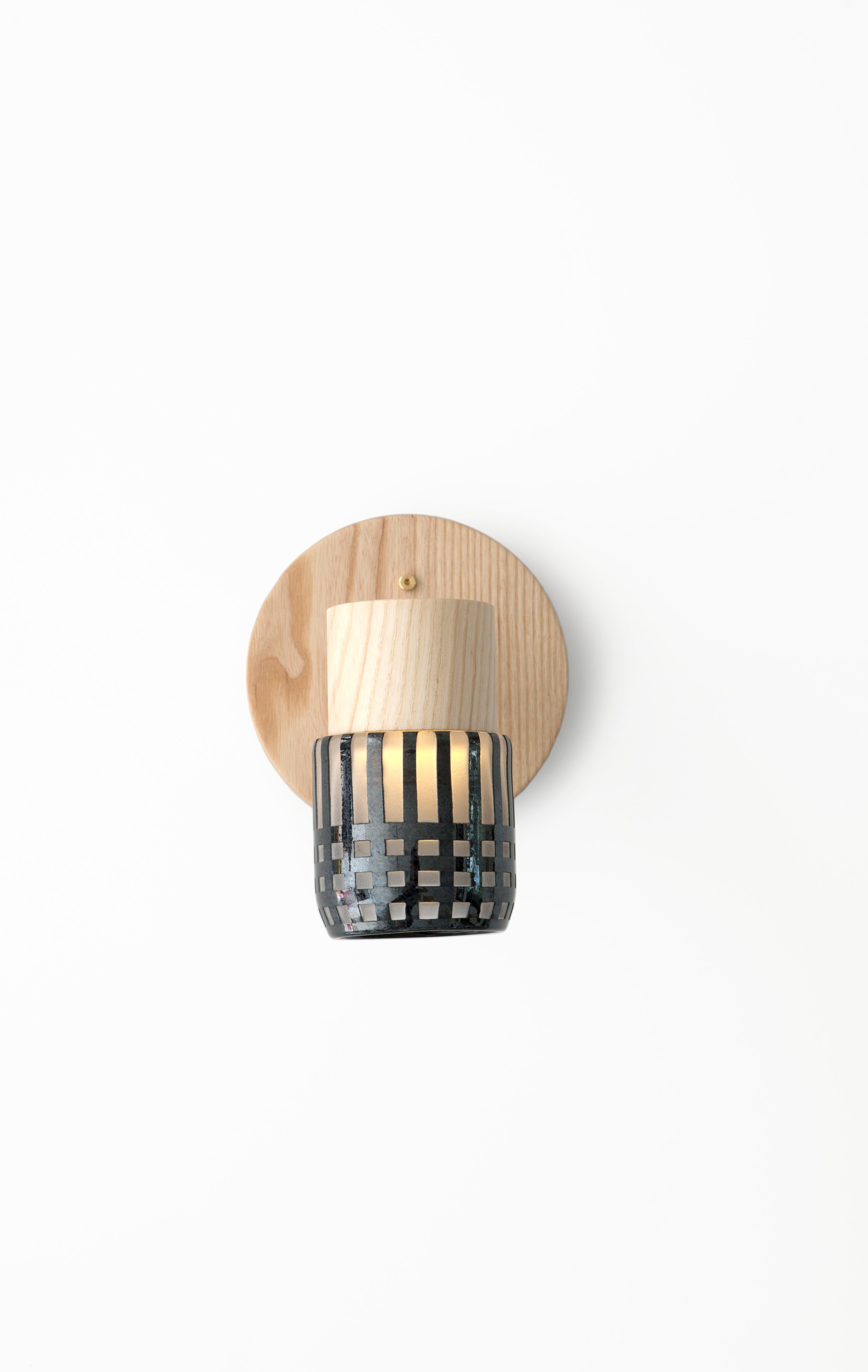 This handmade sconce pairs a minimal solid wood canopy with a hand blown glass diffuser. Efficient LED lighting components are neatly hidden in each canopy allowing the glass diffuser to illuminate without a visible bulb. 

Built in the Pacific