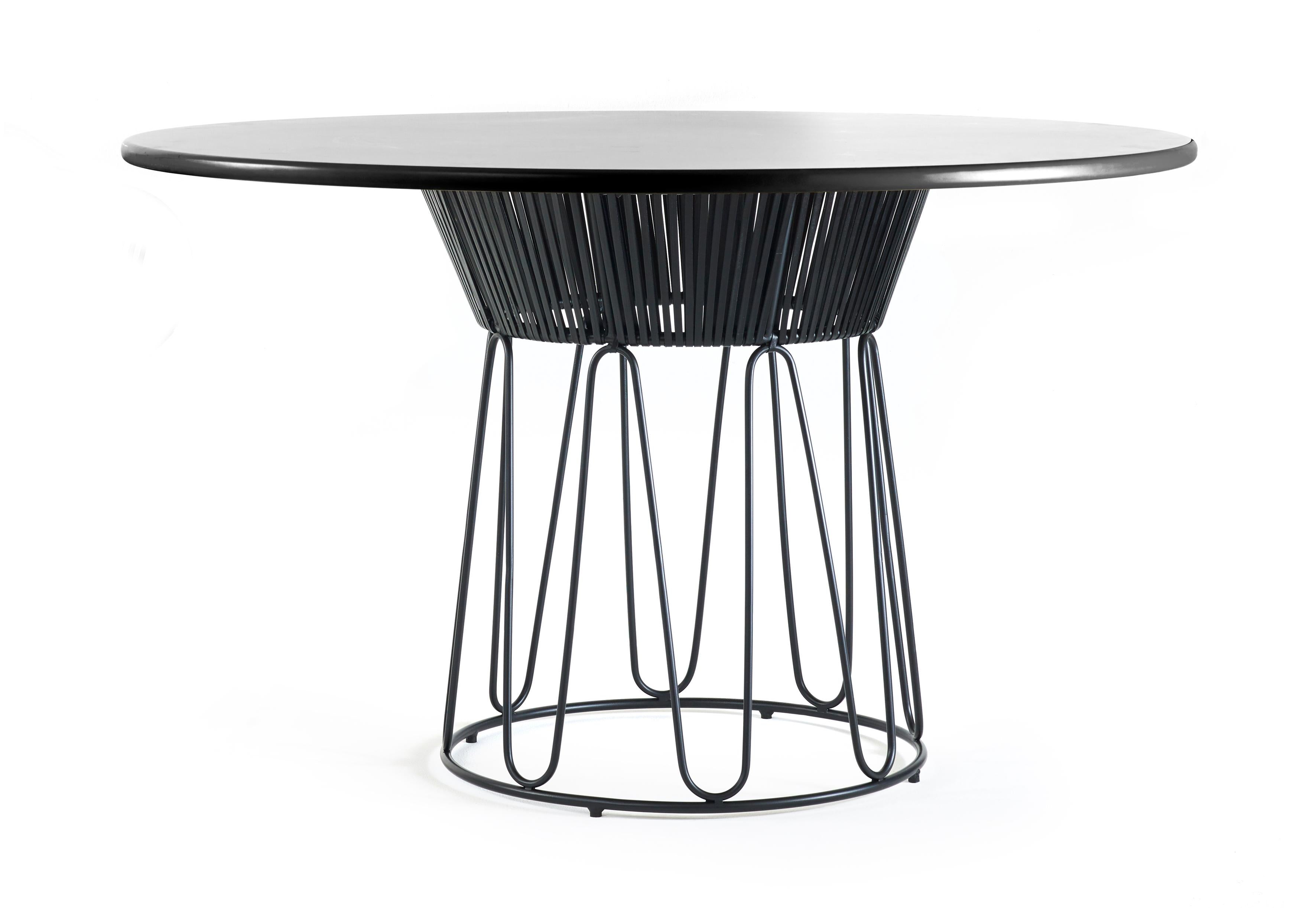 Circo dining table leather by Sebastian Herkner
Materials: Galvanized and powder-coated tubular steel. Aluminum top. Leather. 
Technique: Weaved by local craftspeople in Colombia. 
Dimensions: 
Top diameter 135 cm 
Base diameter 59 x height