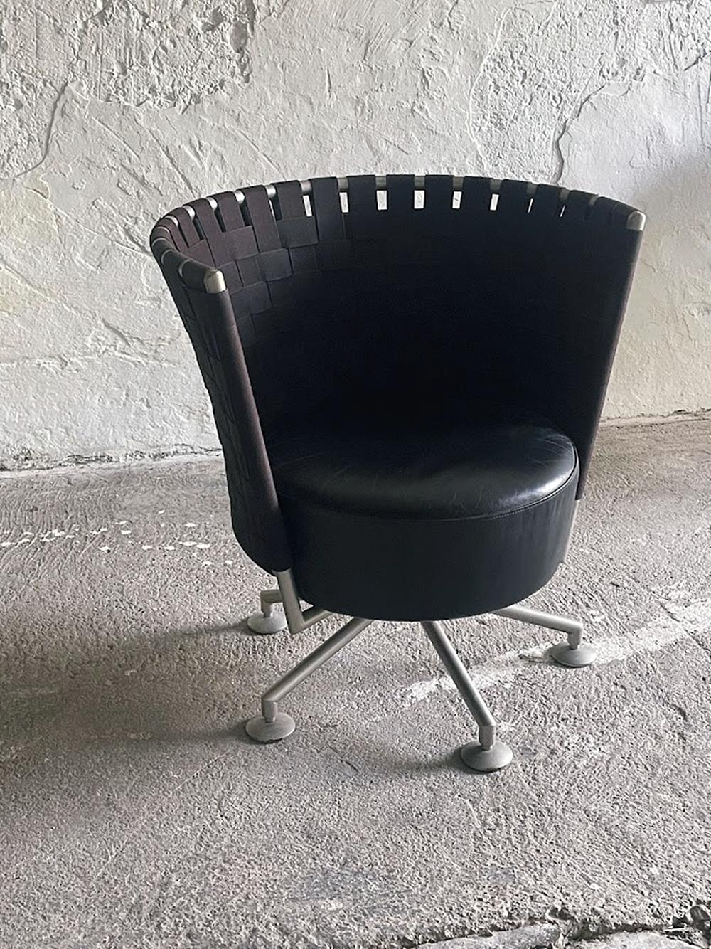 Explore this distinctively designed CIRCO swivel chair, created in 1999 by renowned German designer Peter Maly for COR. The piece blends post‑modern charm with functional elegance. A metal frame forms a semicircular, artful backrest tightly woven