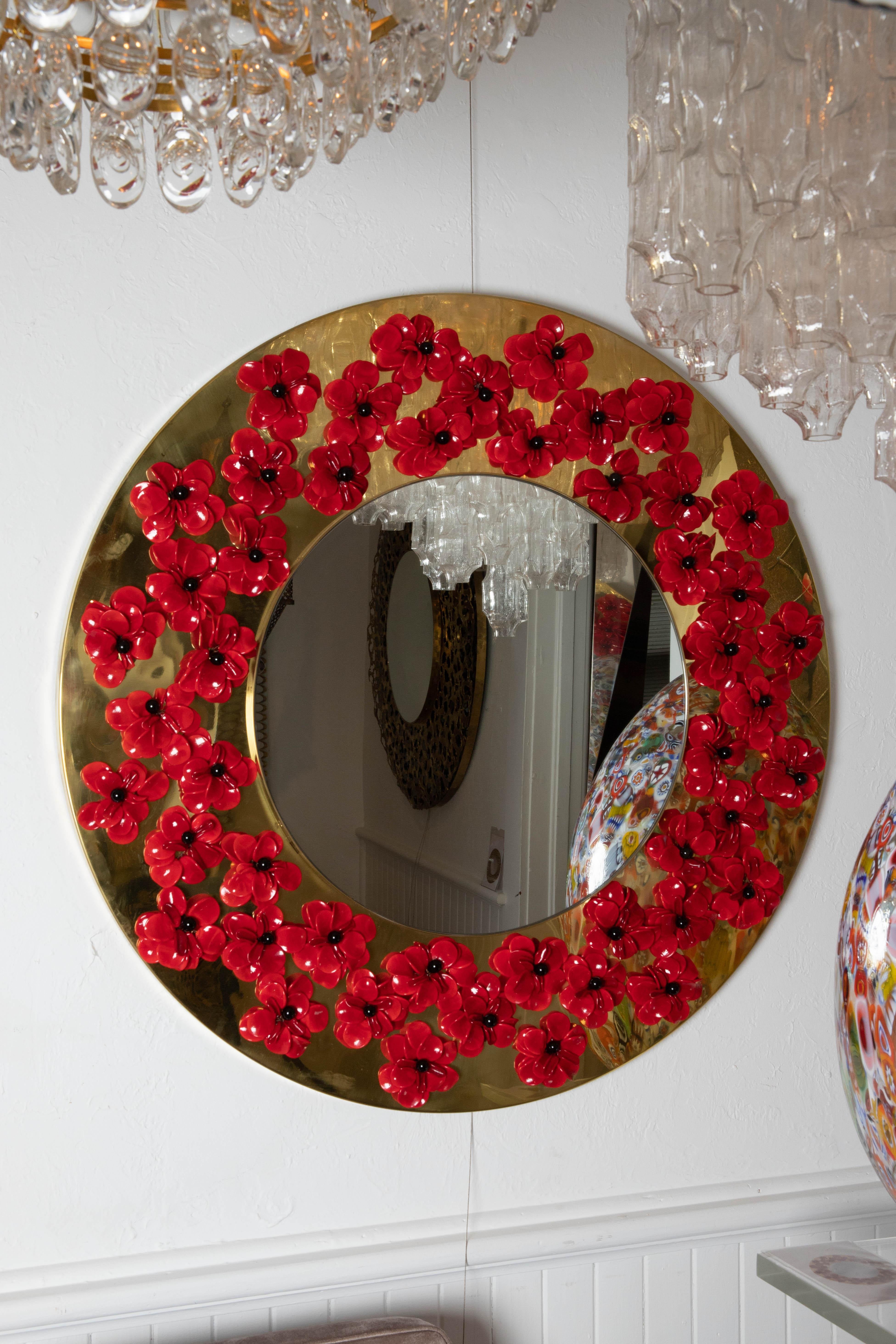 Circular brass mirror with Murano glass flowers.