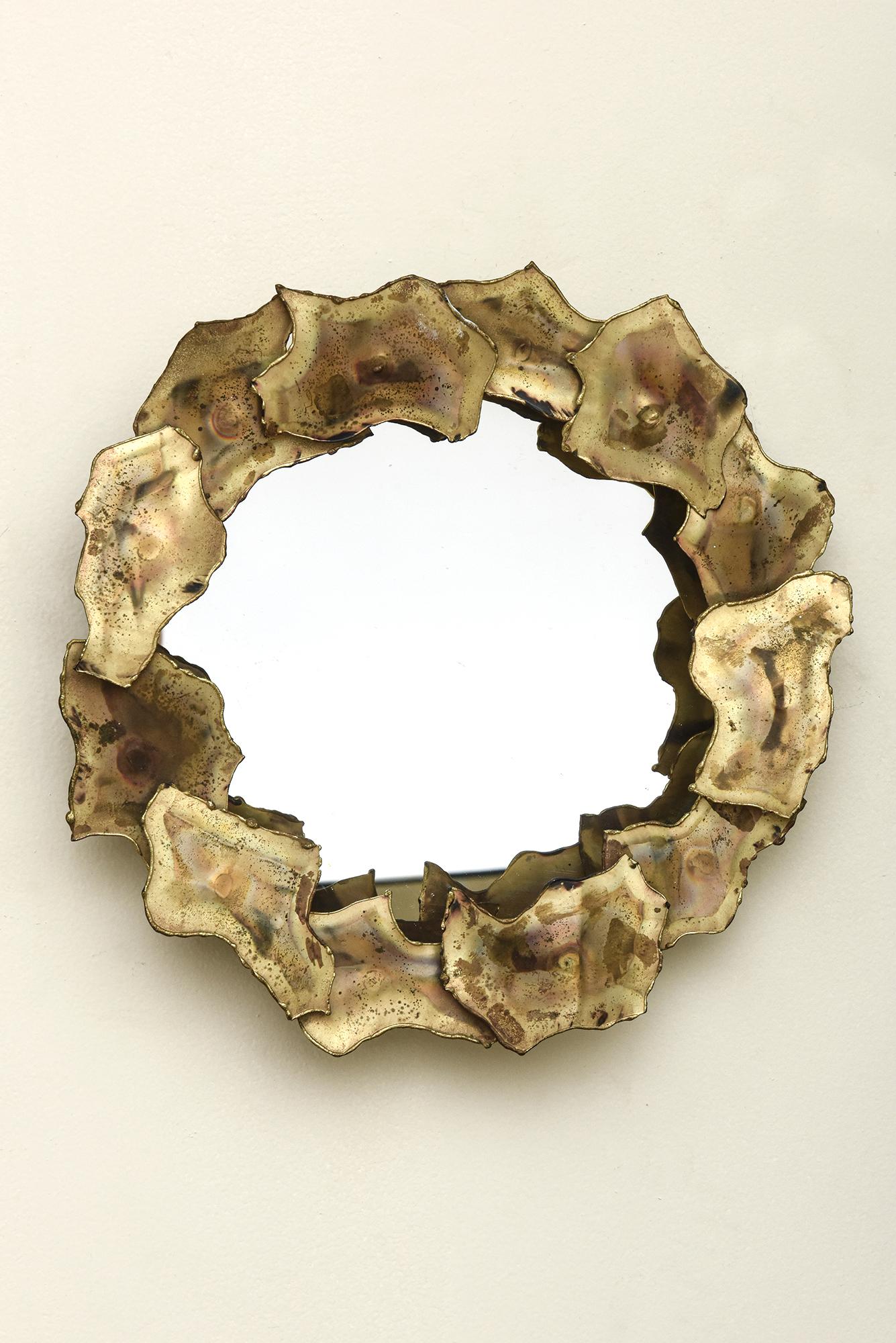 This small vintage table mirror, tray or wall mirror has torched brass elements that are set on nails to give it height. The overlapping of the brass in the style of Silas Seandel is Brutalist style. It can stand alone or be coupled with other like