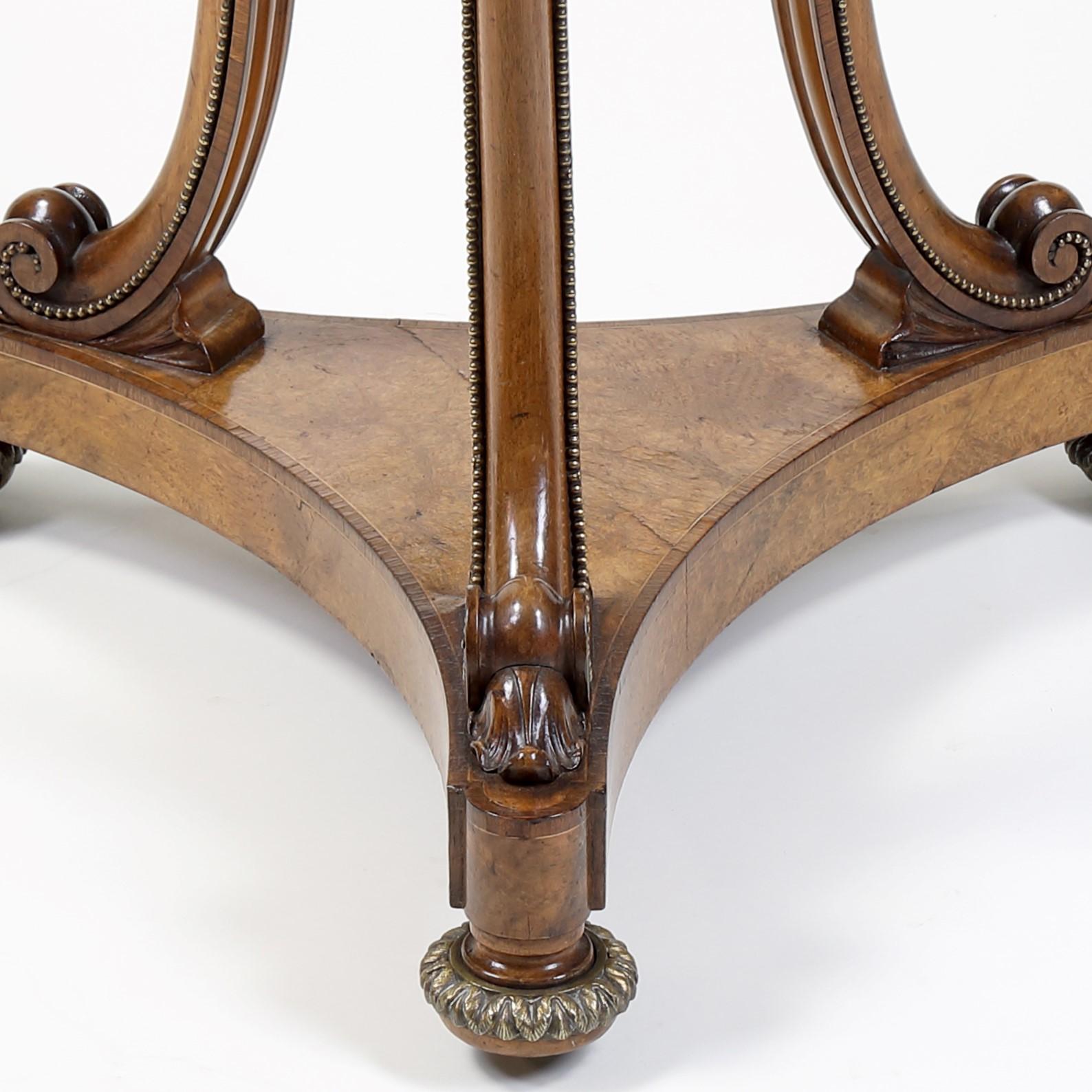 A very fine quality early 19th century burr walnut circular occasional table with ‘Verona-Rosa’ marble top supported on three moulded ‘C’ scroll legs edged with ormolu beading, on a tripartite cross-banded base and gilded bun feet. The legs joined