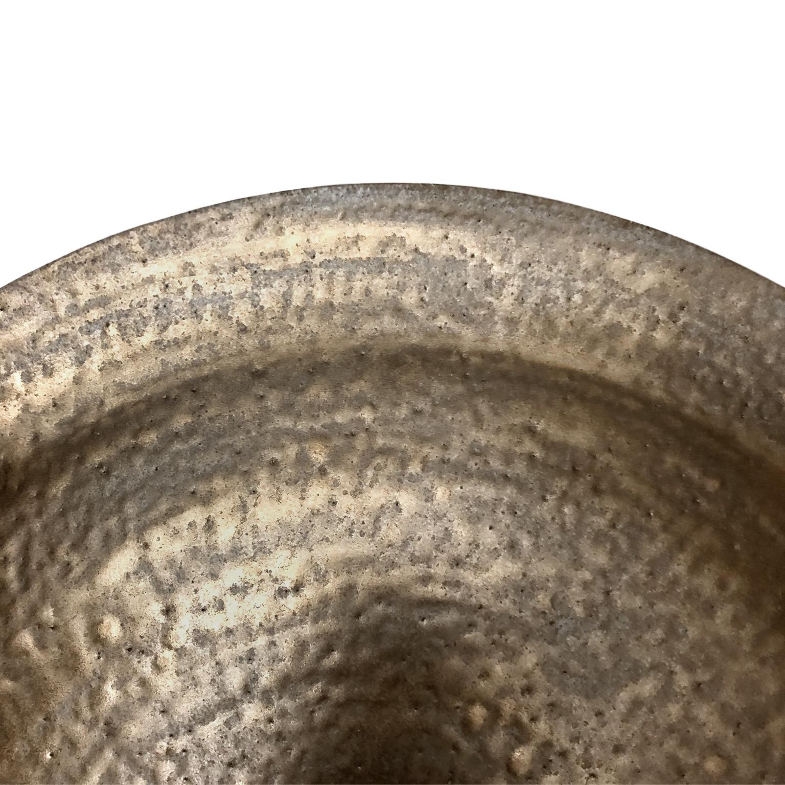 Circular ceramic wall sculpture #3 with dappled bronze glaze by Sandi Fellman, 2020.