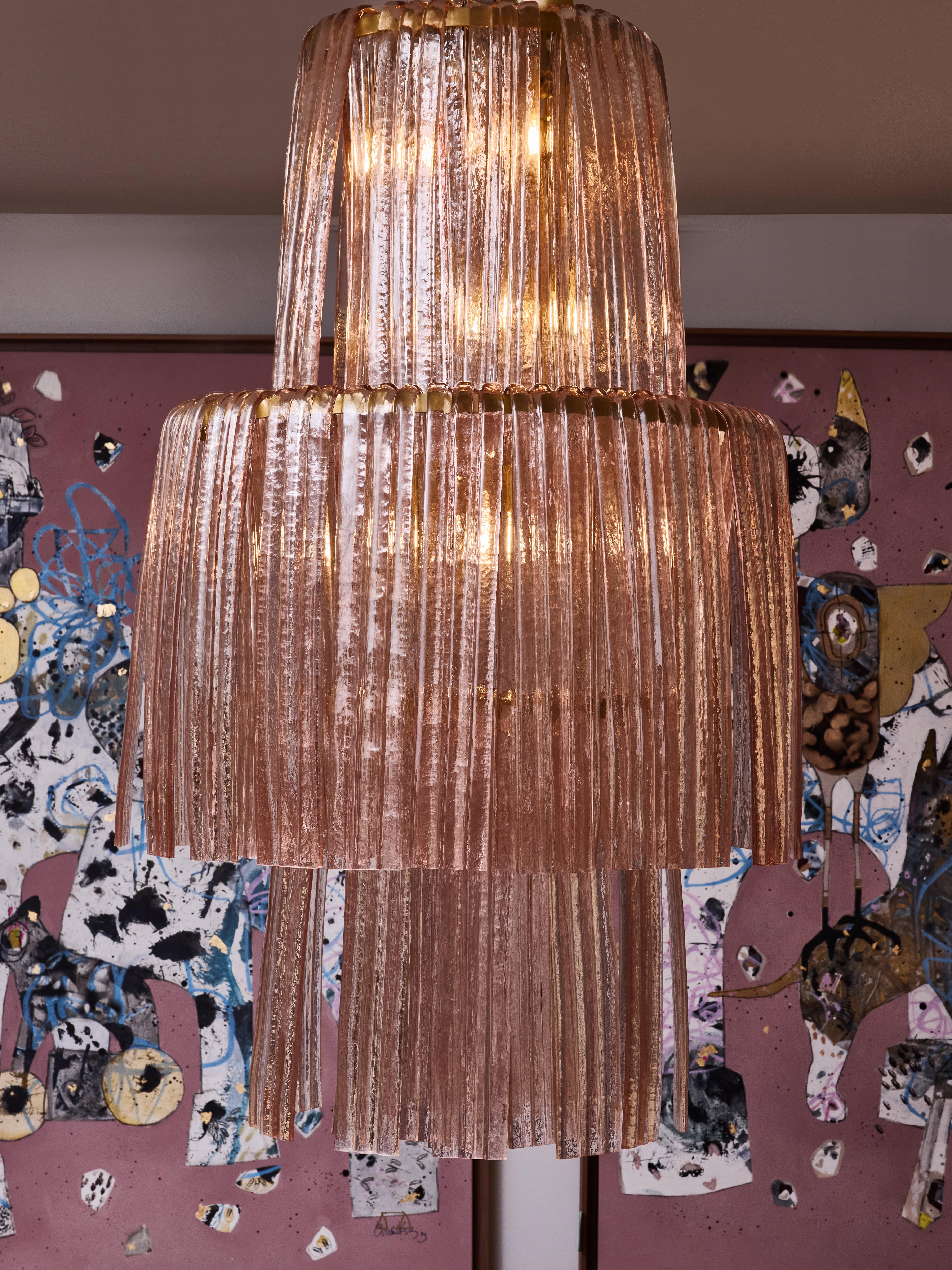 Brass chandelier with important pieces of sculpted pink Murano glass.
Creation by Studio Glustin.
Italy, 2024.