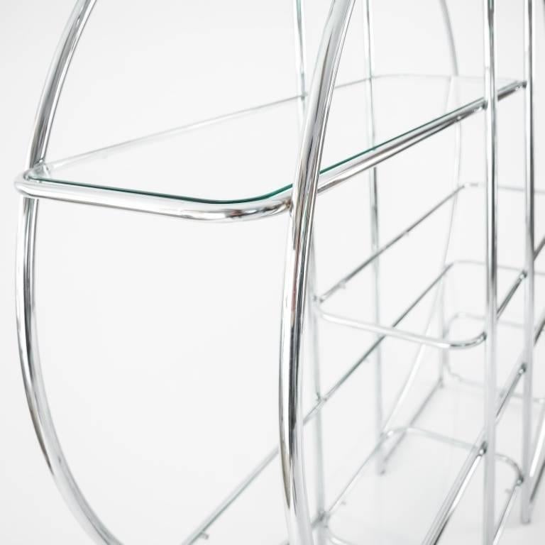 Remarkable chrome-plated round etagere or vitrine or book case in the manner of Milo Baughman with six various sized glass shelving. This piece can be put against the wall but is also great to use as room divider. Great piece and a case example of