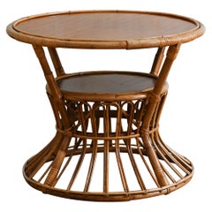 Circular coffee table with rattan motifs and wooden shelves, 1960s