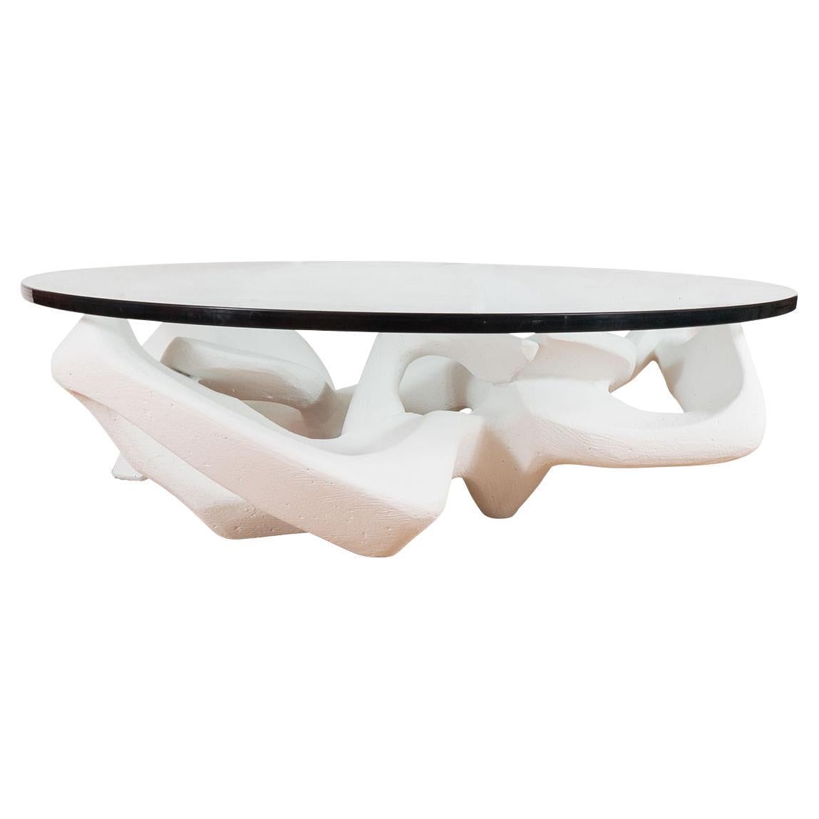 Circular coffee table with white composite base For Sale