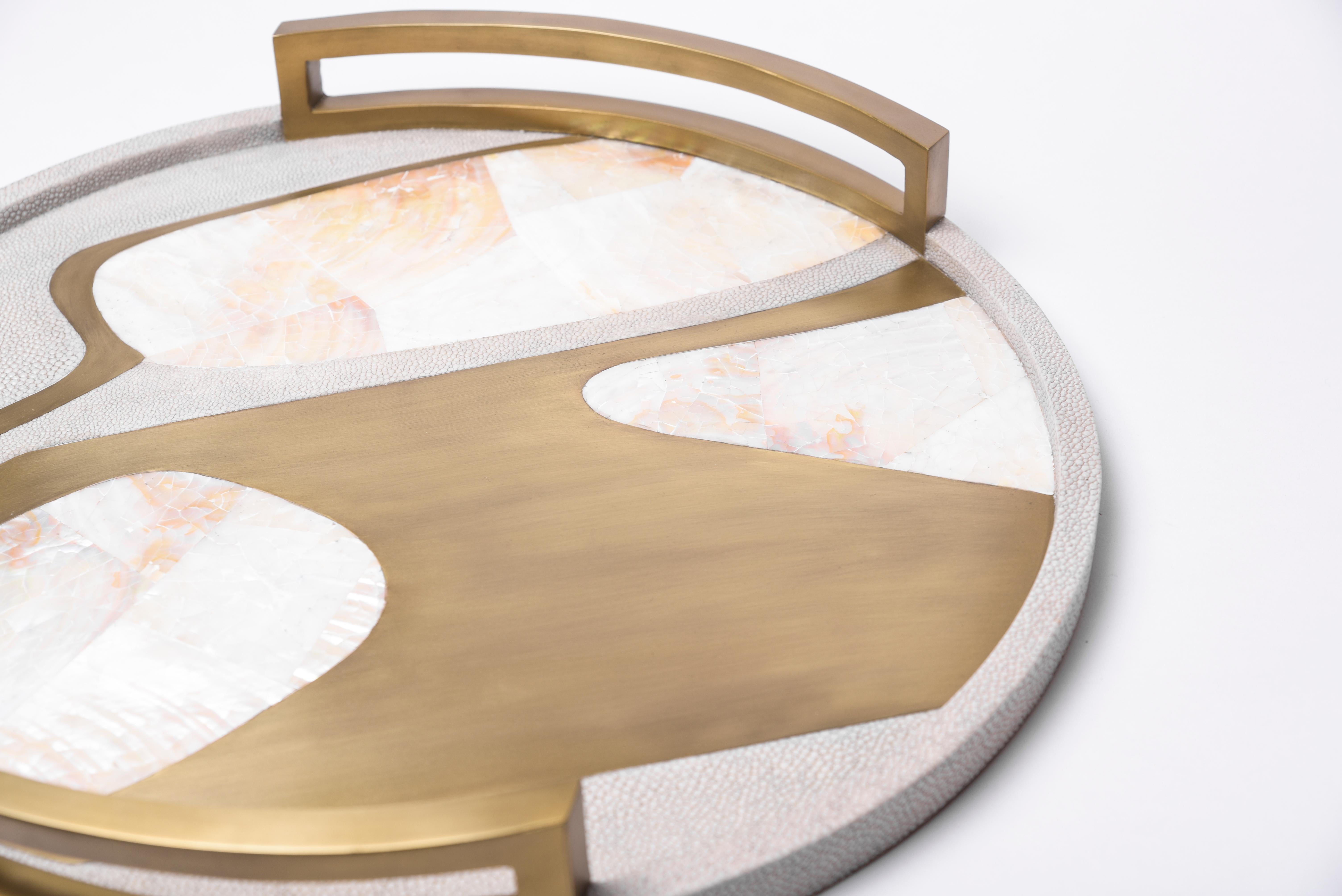 Das runde Cosmos-Tablett ist ein atemberaubendes Tischobjekt für jeden Raum. Erhältlich in heller oder dunkler Ausführung mit Intarsien aus Chagrin, Federmuschel und Bronze-Patina-Messing.

- Maße: 48.5 Durchmesser x 6,3 cm

Alle Stücke von R &